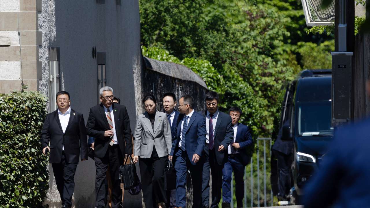 Members of the Chinese delegation leave a residence where trade talks between Chinese and U.S. delegations take place in Geneva