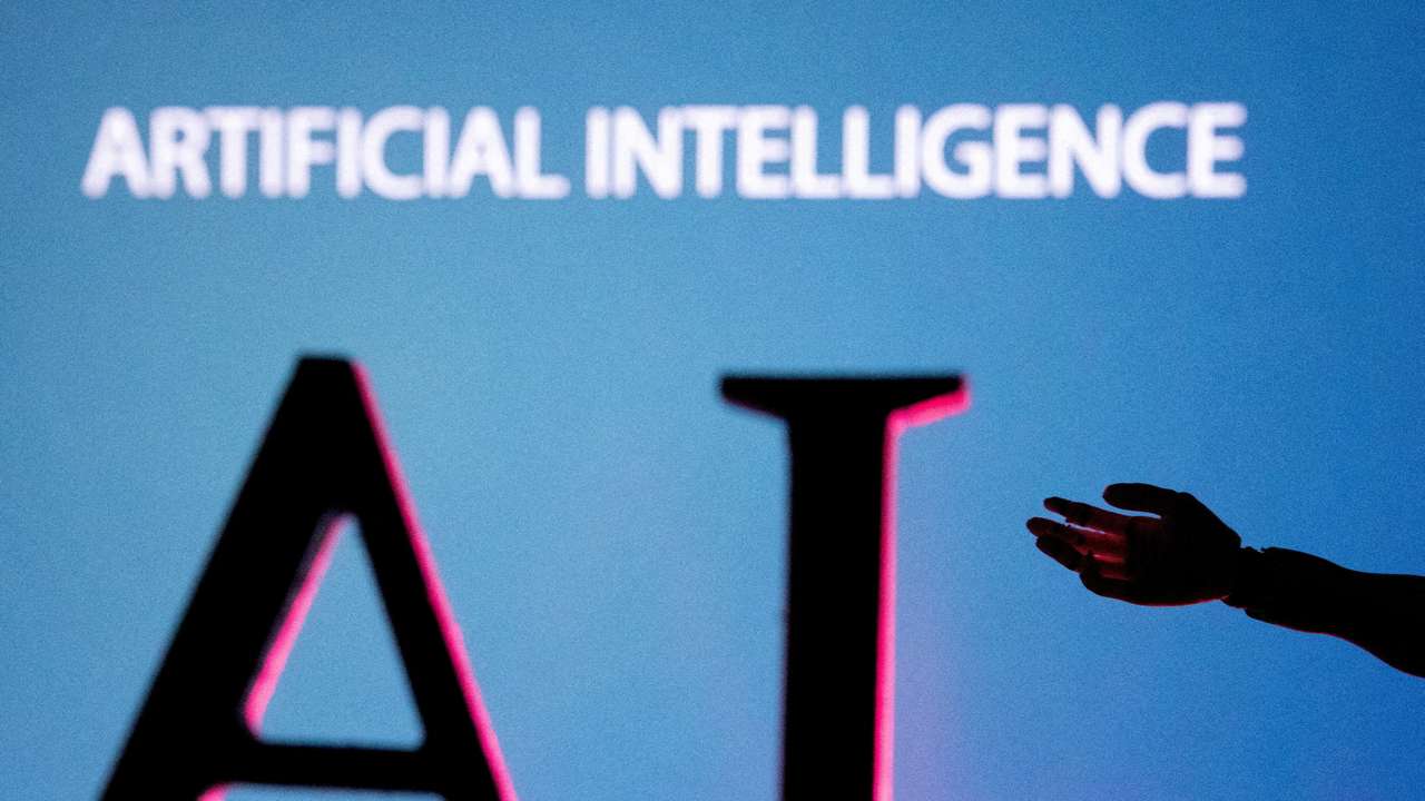 FILE PHOTO: Illustration shows AI (Artificial Intelligence) letters and robot hand miniature
