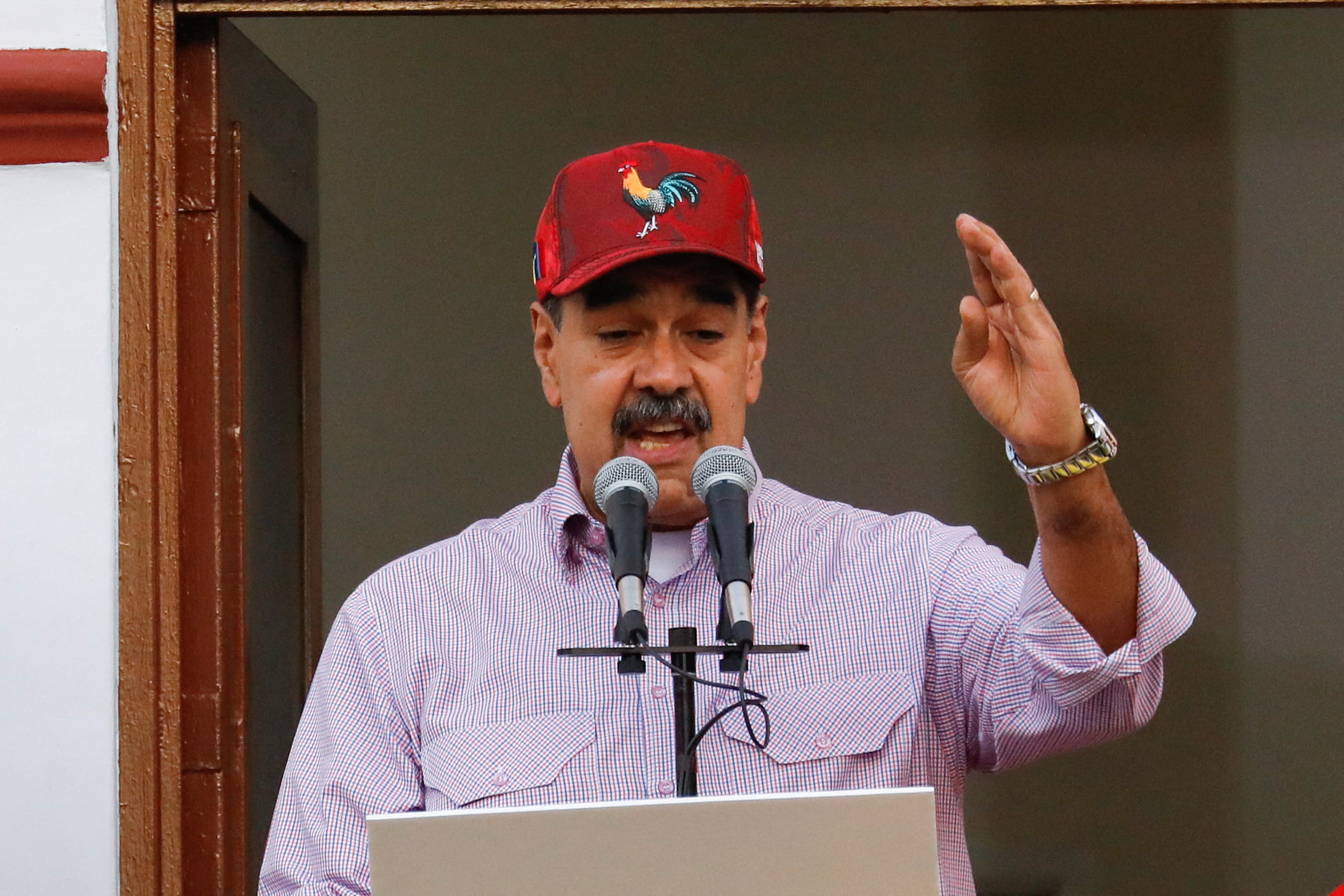 Venezuelan President Nicolas Maduro addresses supporters during a march marking the first anniversary of his victory in the disputed July 28 presidential election