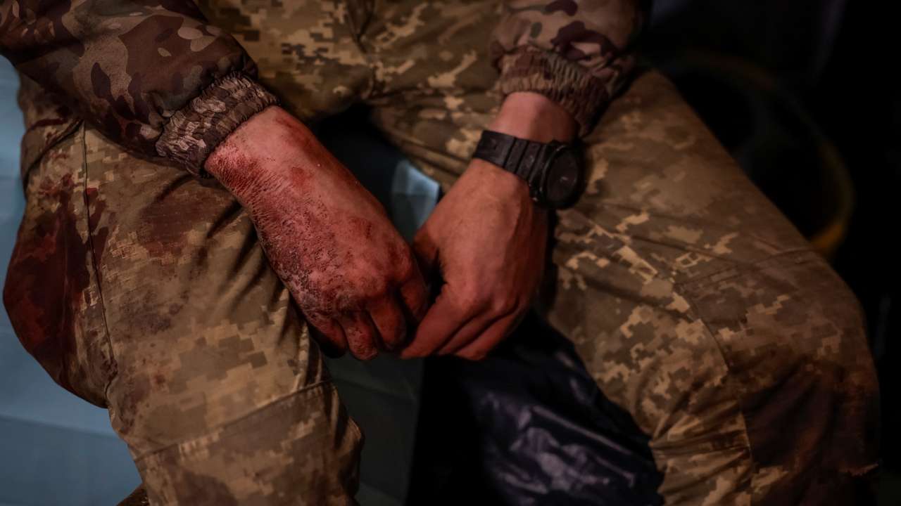 Medics help wounded Ukrainian service members inside a medical stabilisation point, in Zaporizhzhia region