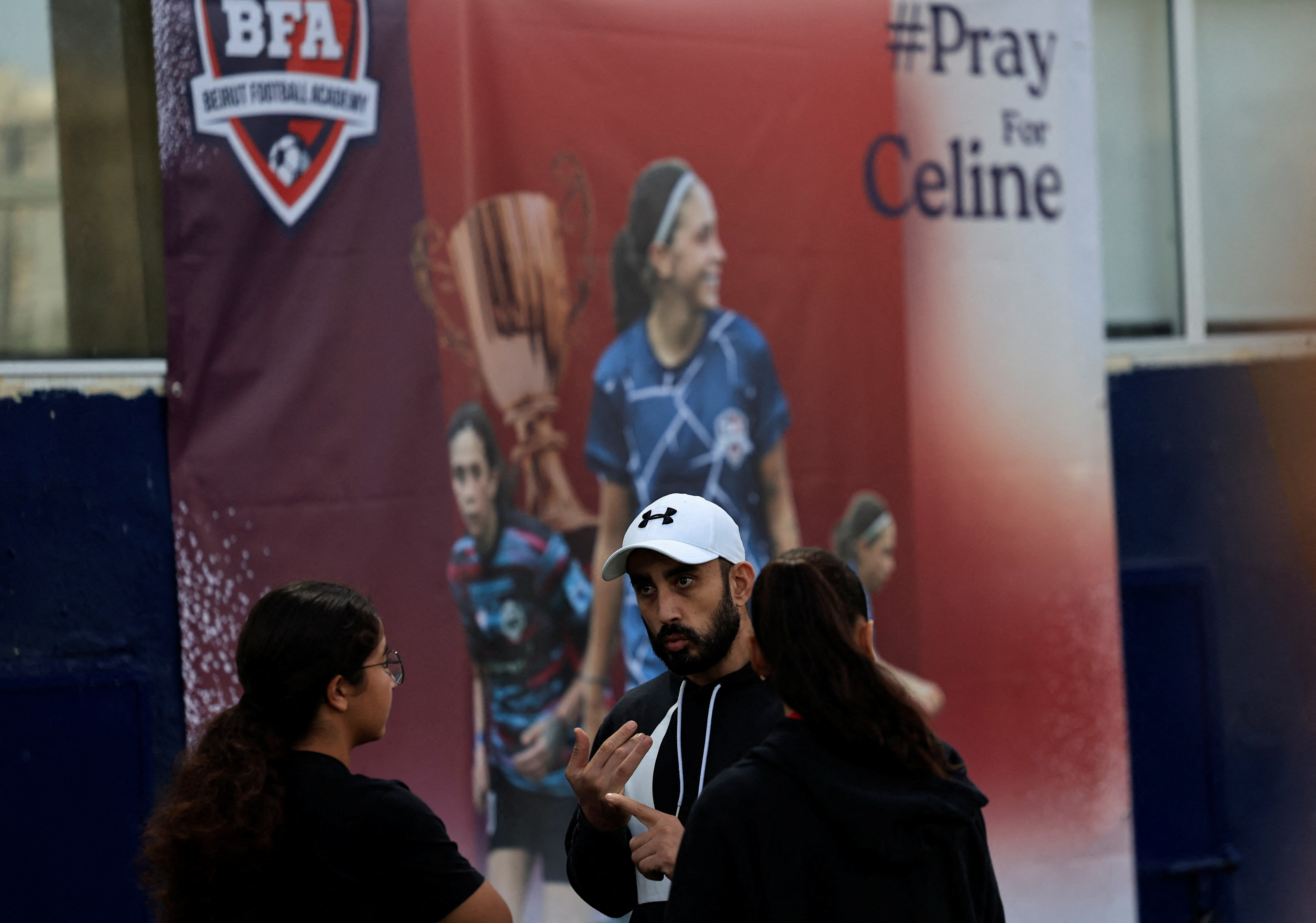 Samer Barbary, coach of Celine Haidar, talks with Celine's teammates at Beirut Football Academy in Furn El Chebbak