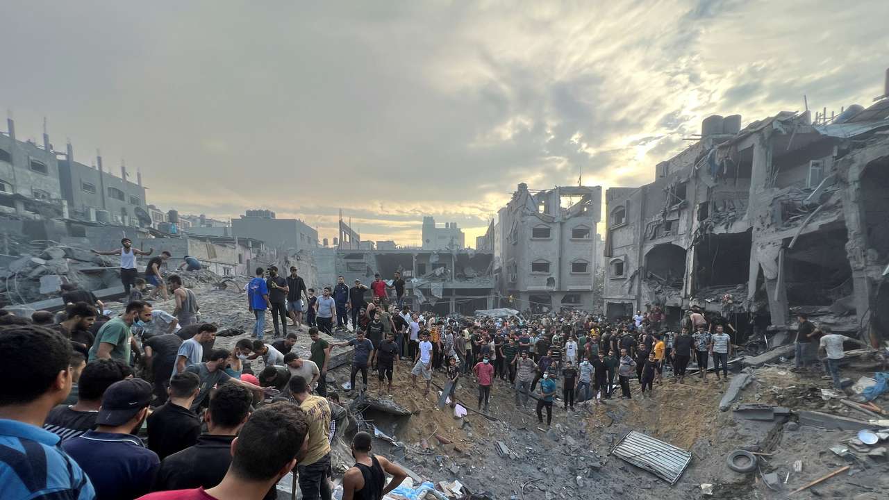 Palestinians search for casualties at the site of Israeli strikes on houses in Jabalia refugee camp