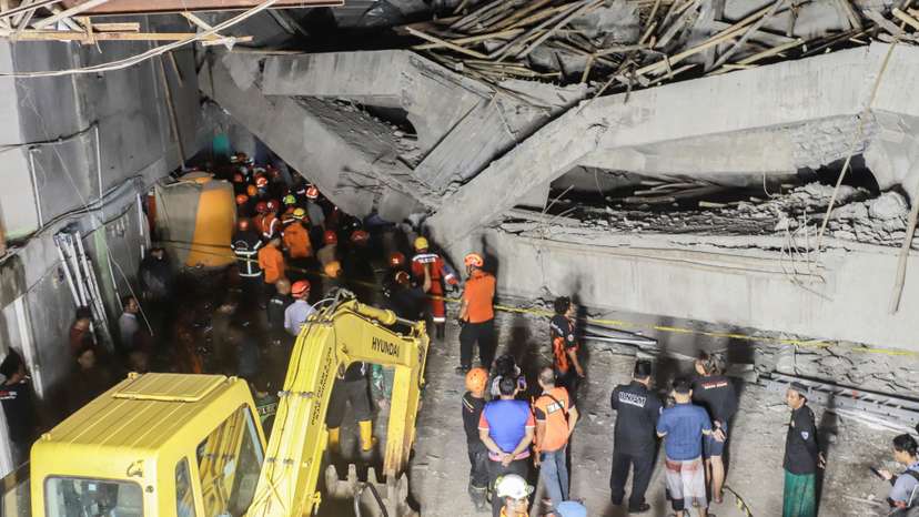 Search and rescue officers search for victims in the rubble of a collapsed building at an Islamic boarding school in Sidoarjo