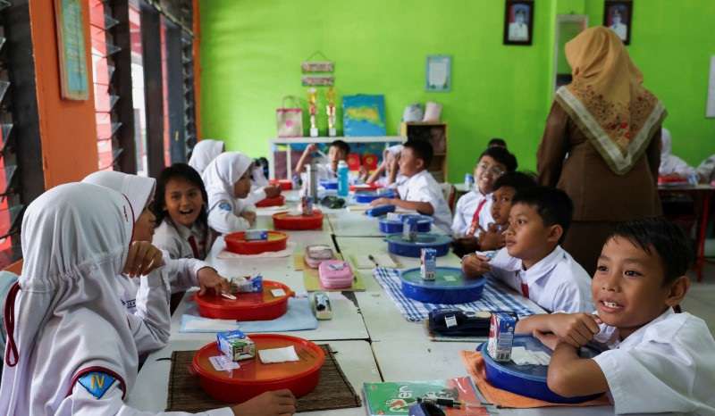 Students attend a free-lunch programme trial at an elementary school in Tangerang