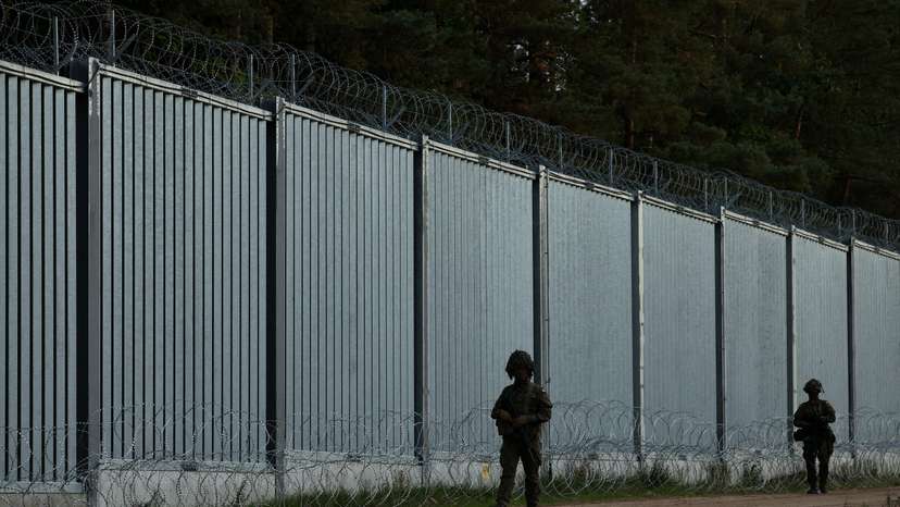 FILE PHOTO: Border guards officers are seen near the fence on the Polish-Belarusian border, during the migrant crisis, in Opaka Duza