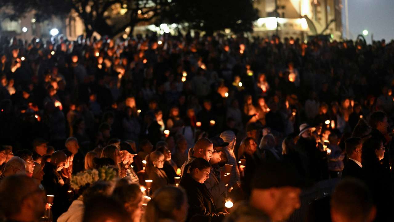 People gather for a candlelight vigil on Bondi Beach to pay respects to the victims of a fatal stabbing attack at a shopping centre in Sydney