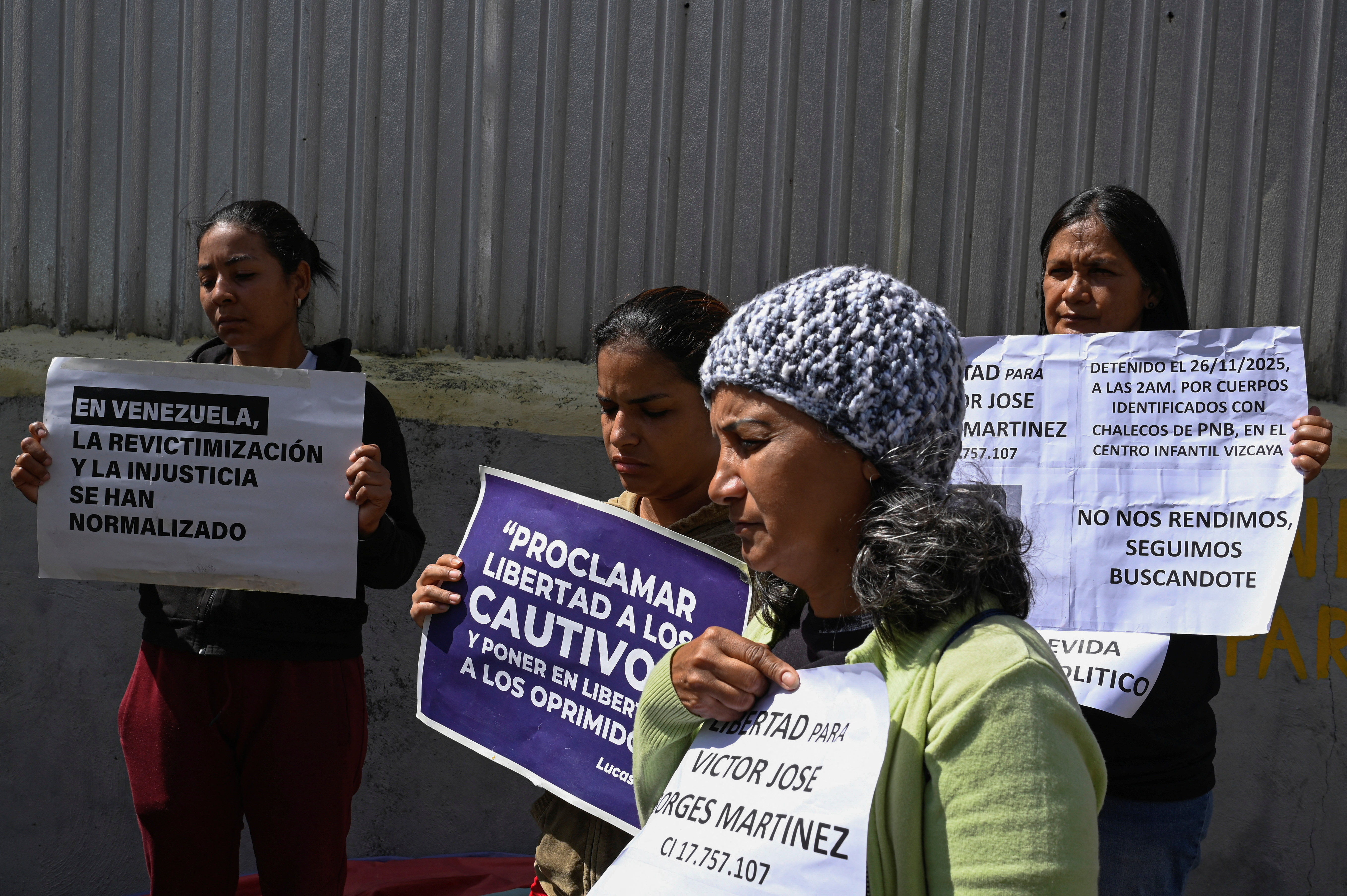 Family members of detainees wait outside the National Police Zone 7 Detention Centre, in Caracas