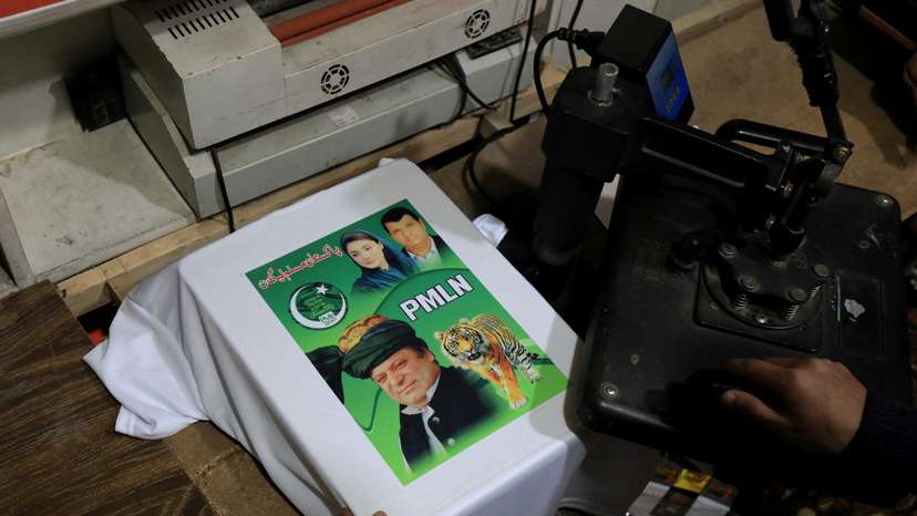 A worker prints a poster depicting Pakistan's former Prime Minister Nawaz Sharif on a t-shirt, in Peshawar
