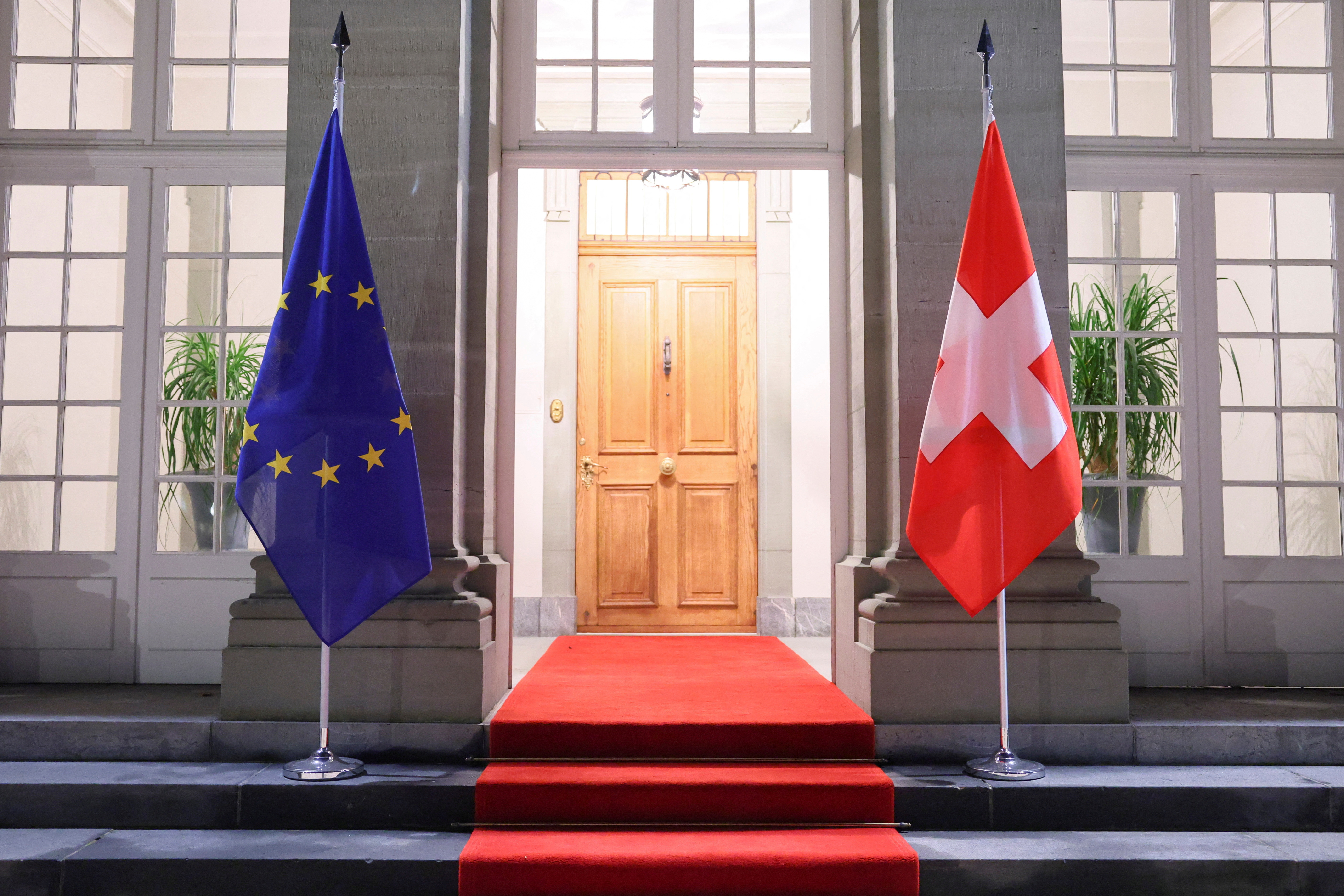 FILE PHOTO: Swiss and EU flags hang at Lohn Estate in Kehrsatz