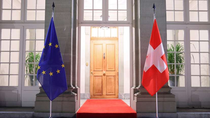 FILE PHOTO: Swiss and EU flags hang at Lohn Estate in Kehrsatz