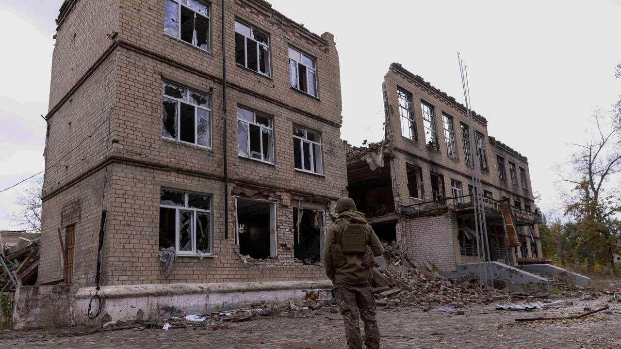 FILE PHOTO: A police officer stands in front of a damaged building in Avdiivka
