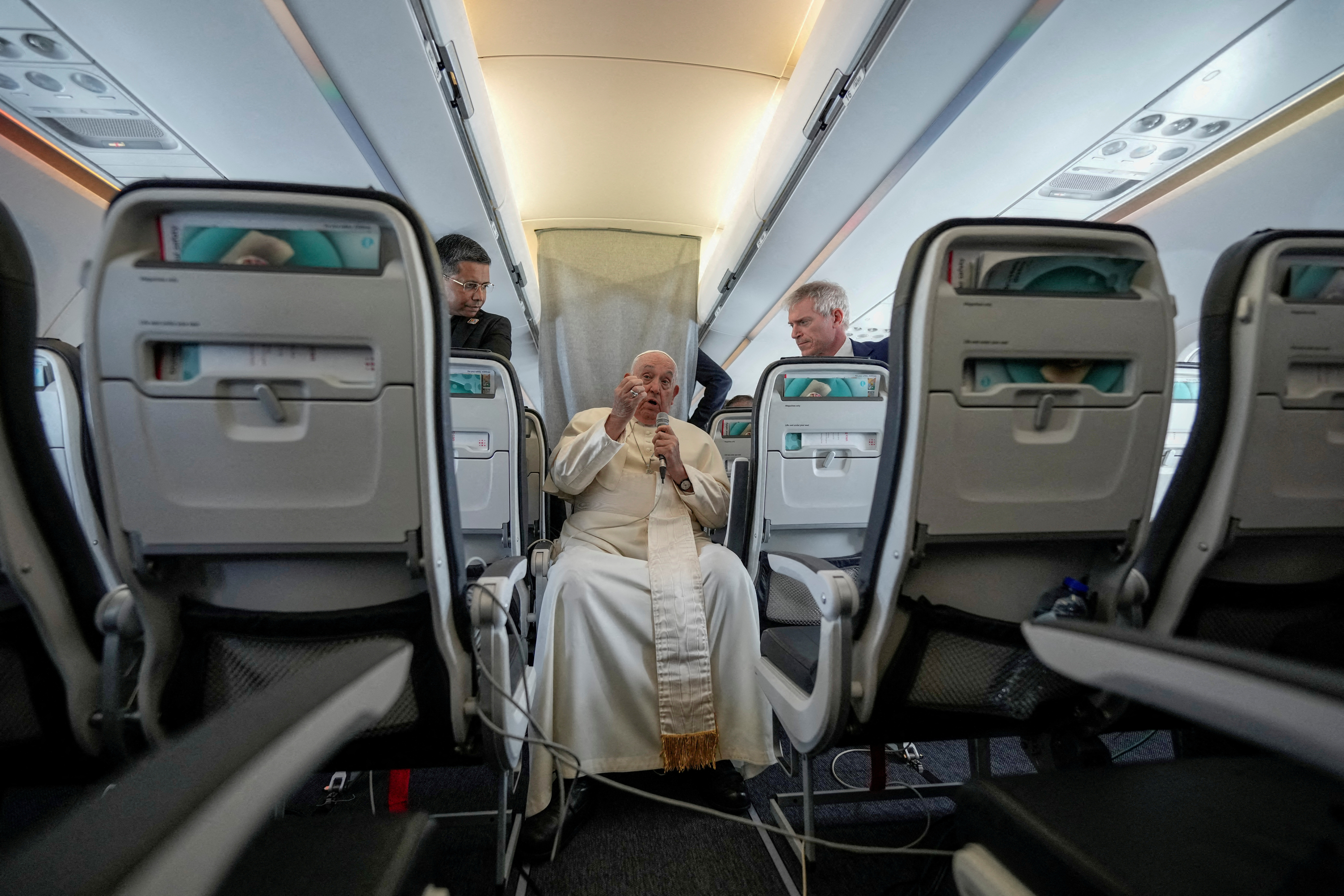 FILE PHOTO: Pope Francis talks to journalists on the flight back to Rome