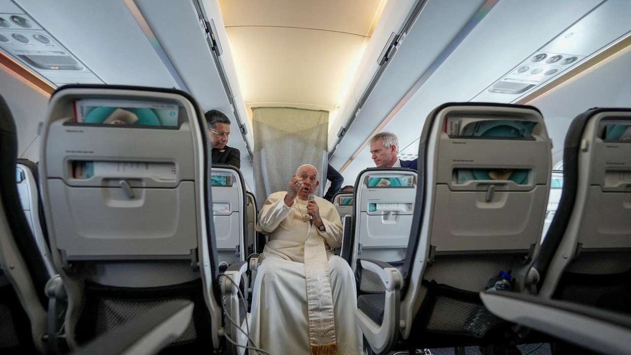 FILE PHOTO: Pope Francis talks to journalists on the flight back to Rome