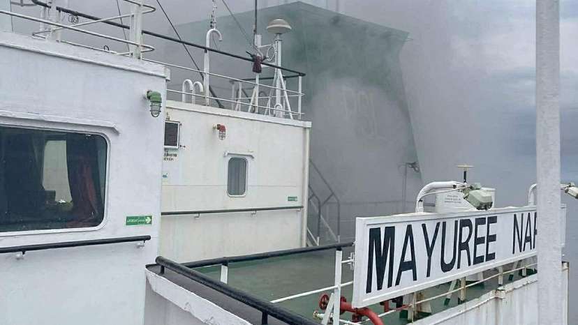 The Thailand-flagged cargo ship Mayuree Naree engulfed in black smoke in the Strait of Hormuz