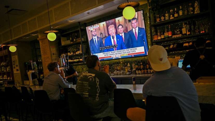 Patrons of the Chapel Street Cafe watch as U.S. President Donald Trump delivers an address to the nation