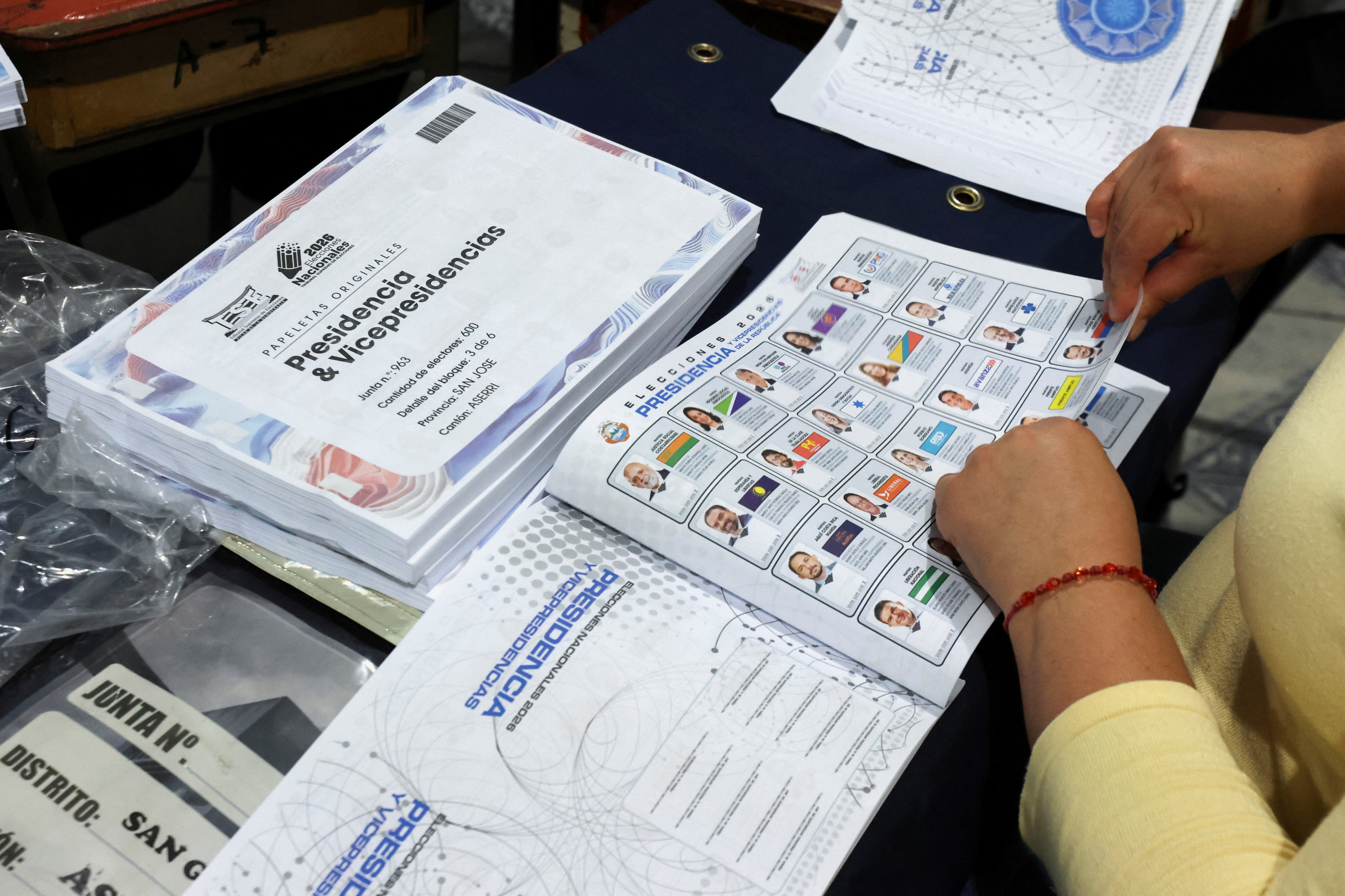 Costa Rican officials hand out voting materials ahead of February 1 general election, in San Jose
