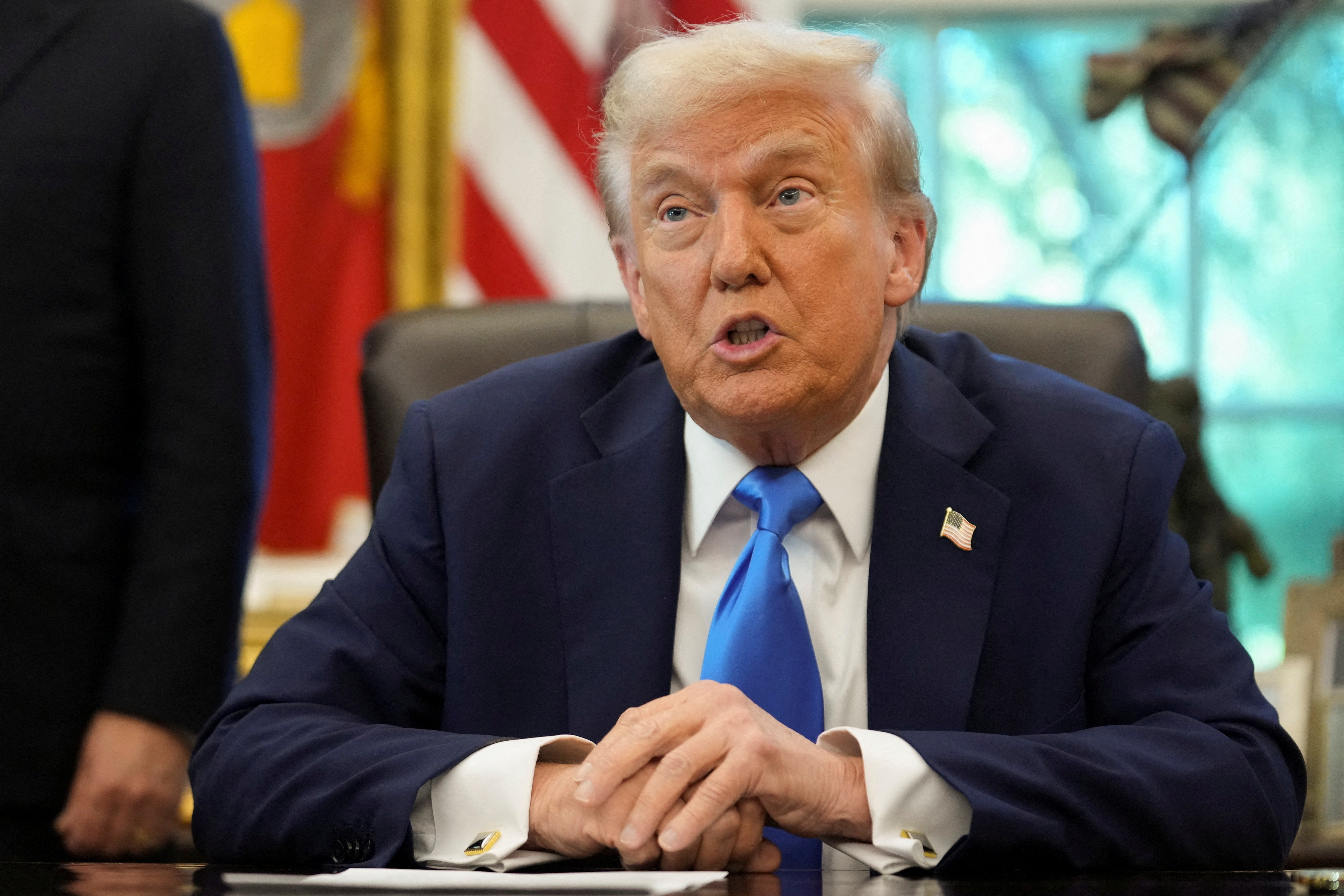 U.S. President Donald Trump signs executive orders in the Oval Office at the White House in Washington