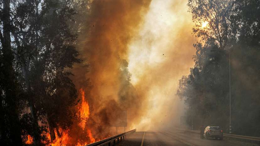 Flames seen at the side of a road, amid ongoing cross-border hostilities between Hezbollah and Israeli forces, close to the Israel border with Lebanon