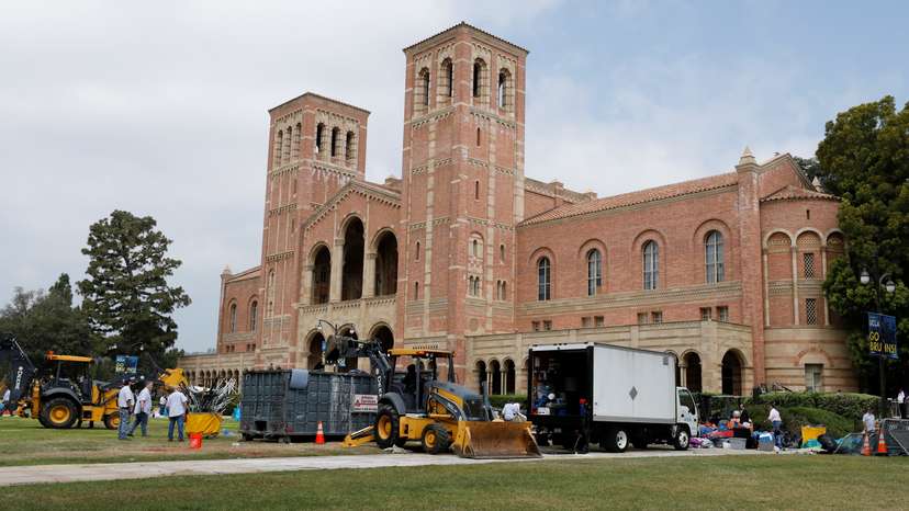 Workers remove the remnants of a protest encampment at University of California Los Angeles