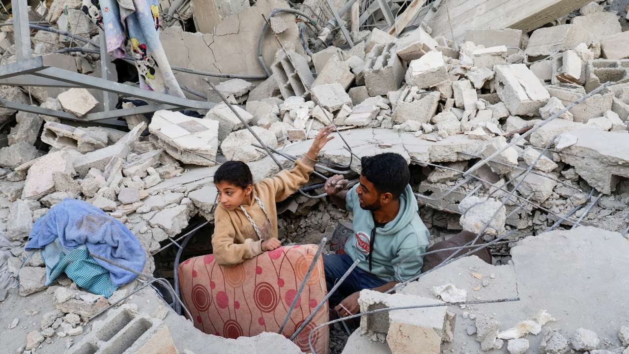 Palestinians gather at the site of an Israeli strike on a house, in Khan Younis
