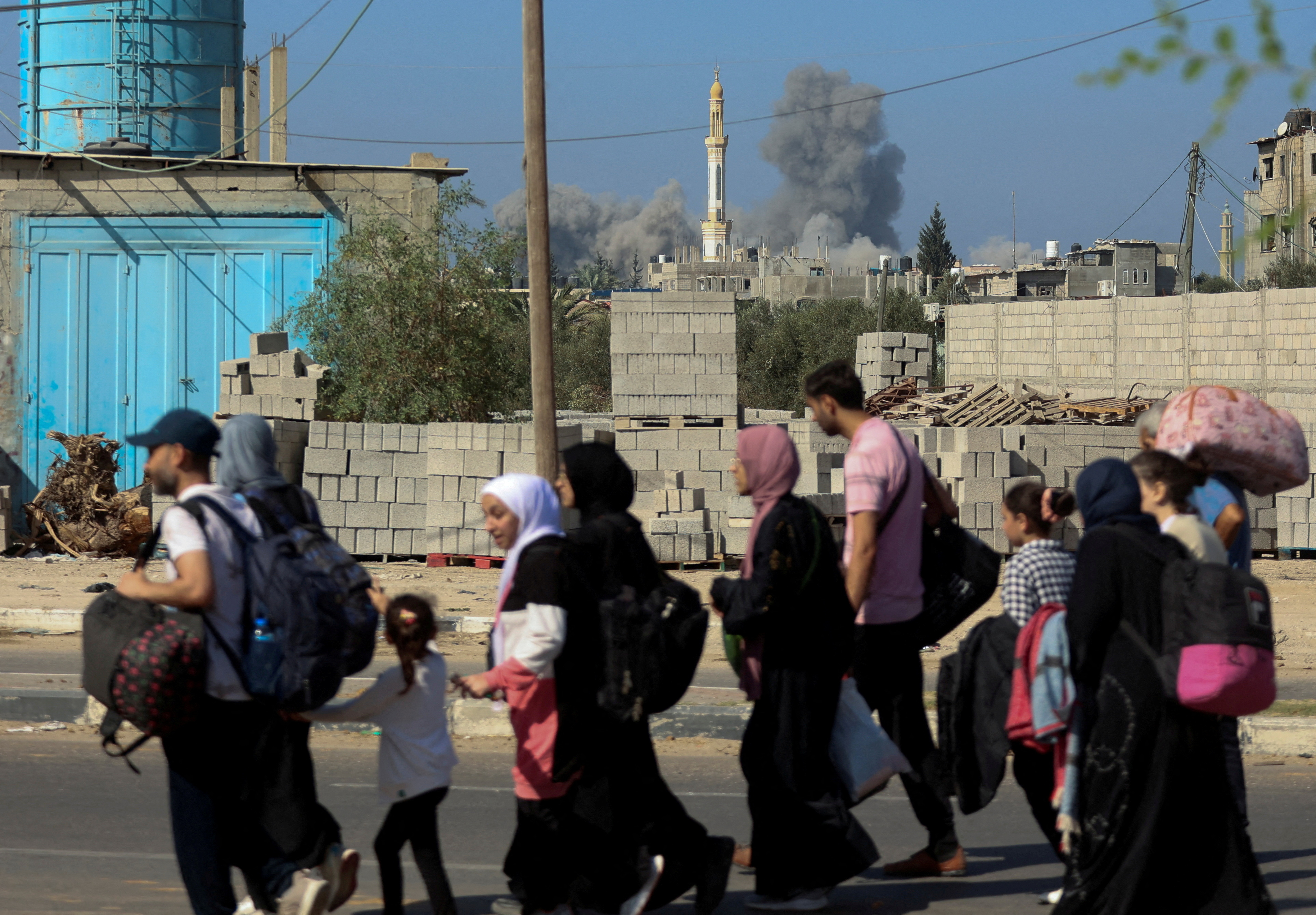 FILE PHOTO: Palestinian civilians evacuating from the north of the Gaza Strip walks towards south