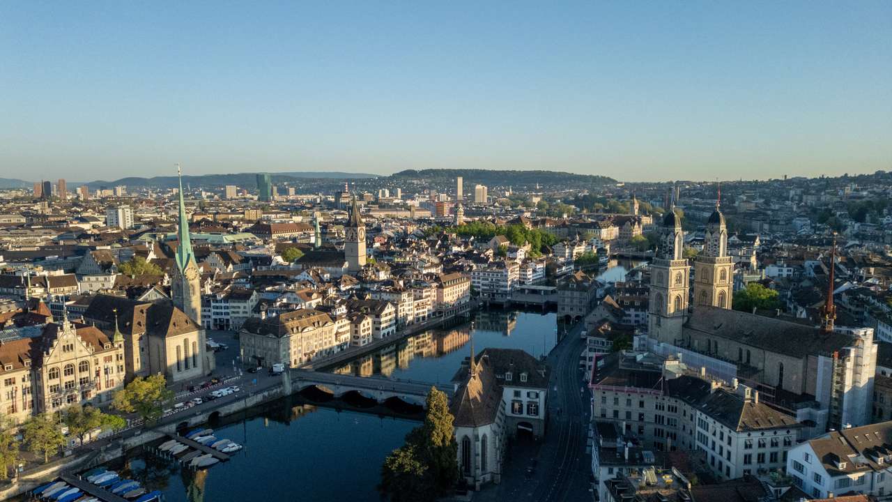 A drone view shows the Limmat river, the Grossmuenster and Fraumuenster churches and the city are seen early morning in Zurich