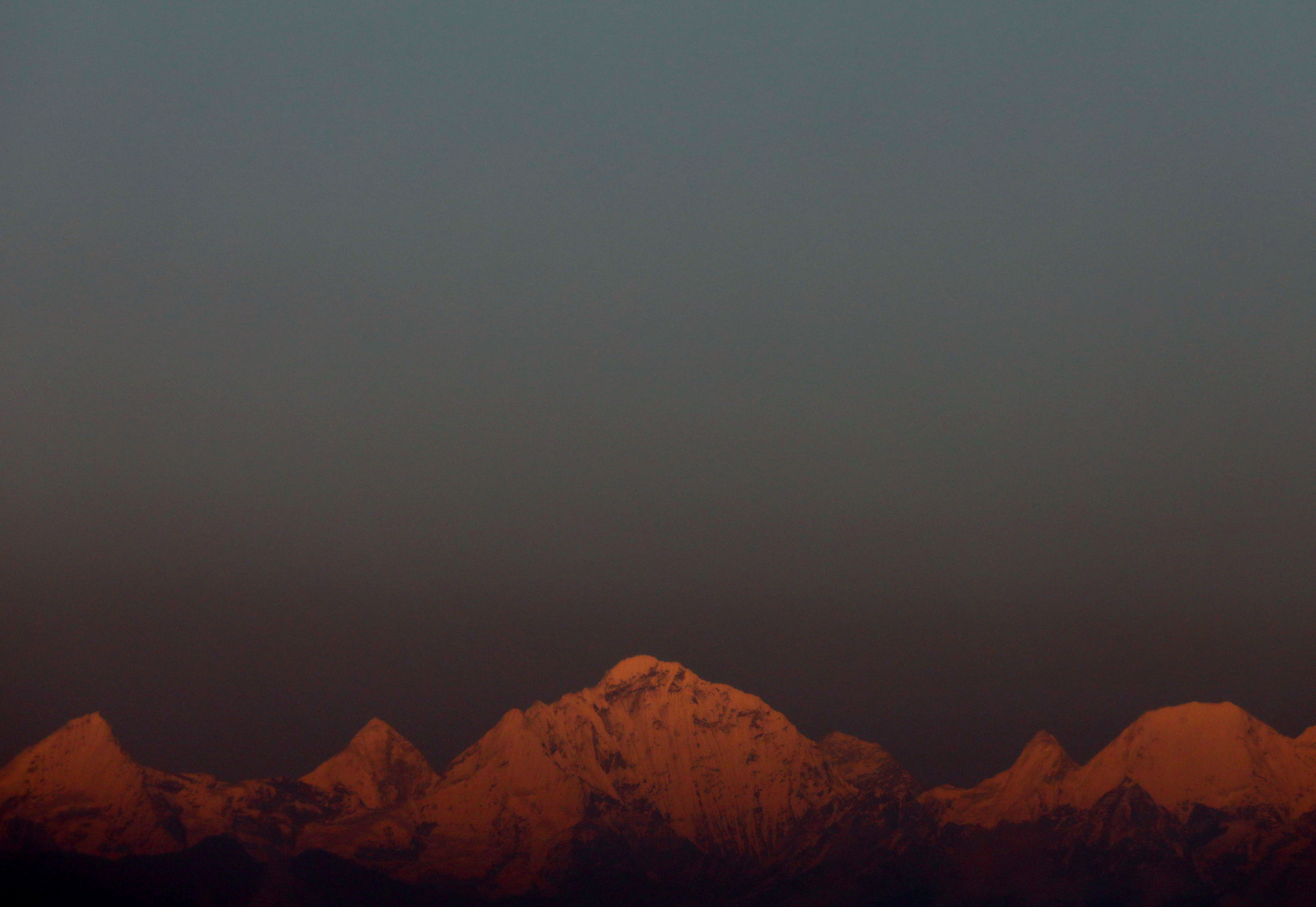 FILE PHOTO: Mount Everest, the world's highest mountain, and other peaks of the Himalayan range are seen during sunset from Kathmandu