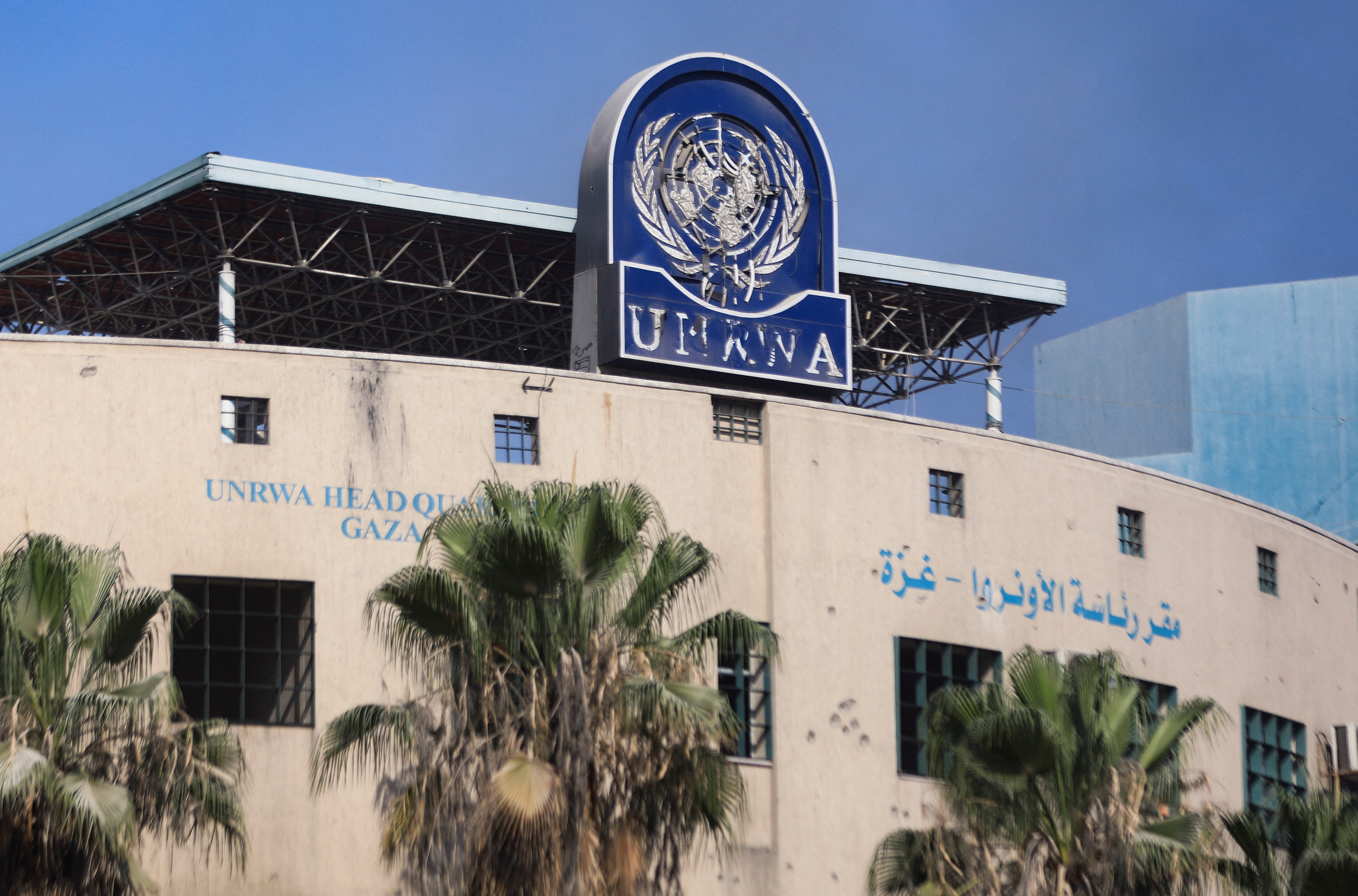 Palestinians gather to inspect the damages at the headquarters of UNRWA in Gaza City