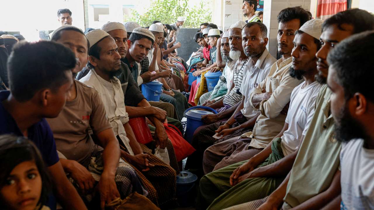 FILE PHOTO: Rohingya refugees wait at the World Food Programme(WFP) distribution center to purchase grocery items, at the refugee camp in Cox's Bazar