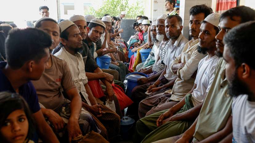 FILE PHOTO: Rohingya refugees wait at the World Food Programme(WFP) distribution center to purchase grocery items, at the refugee camp in Cox's Bazar