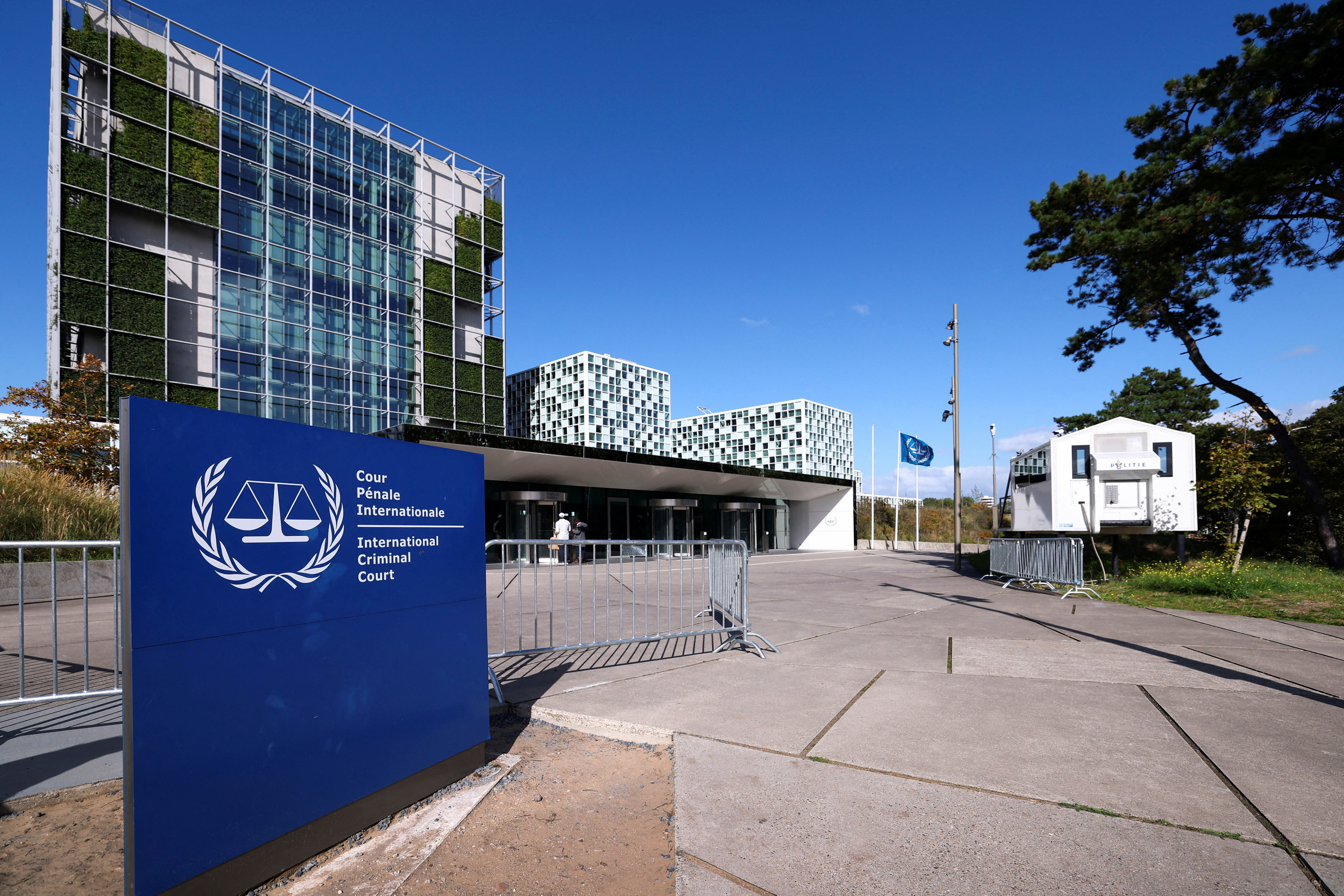 FILE PHOTO: People stand outside the International Criminal Court (ICC)  in The Hague