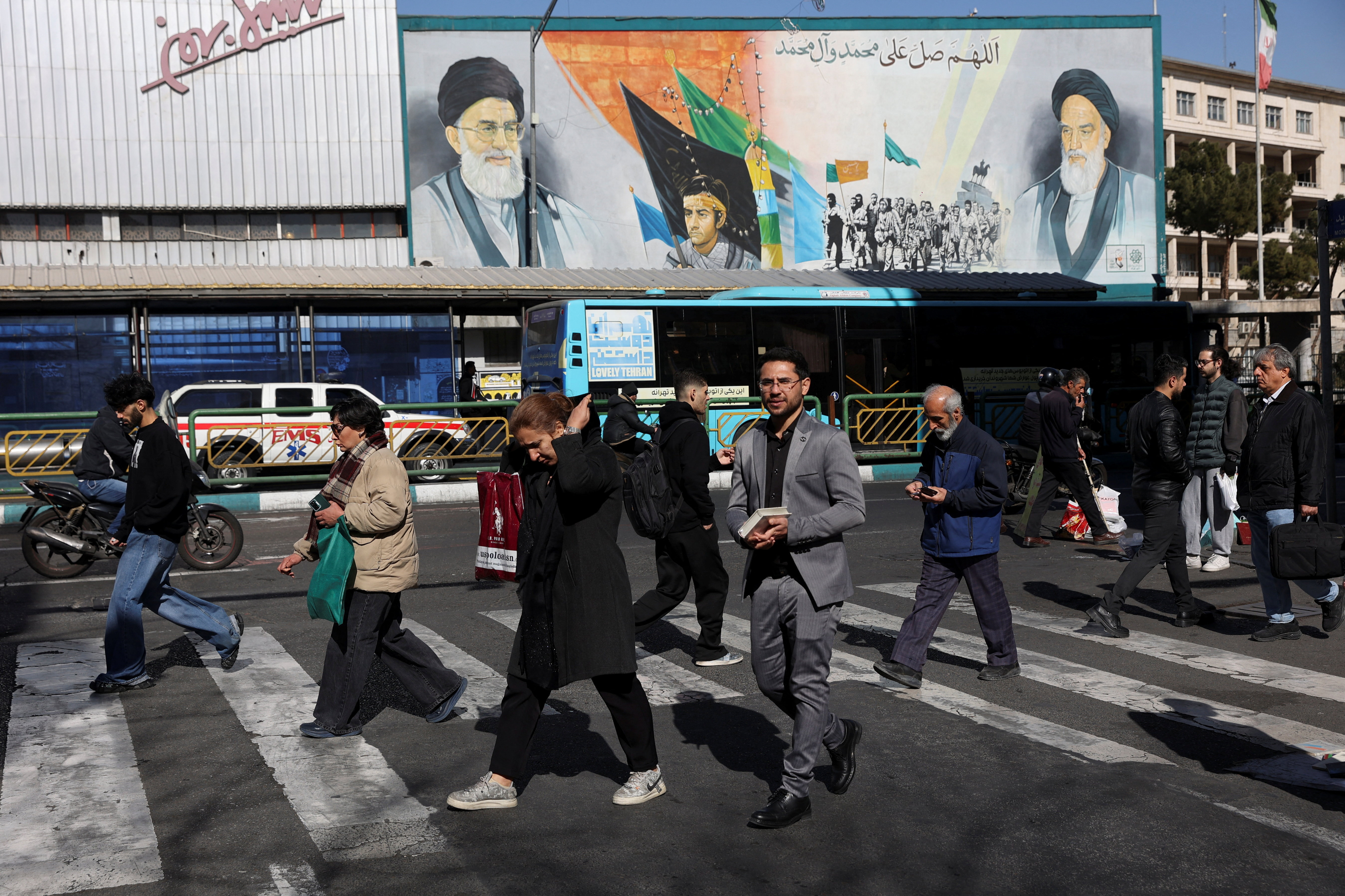 People walk on a street in Tehran