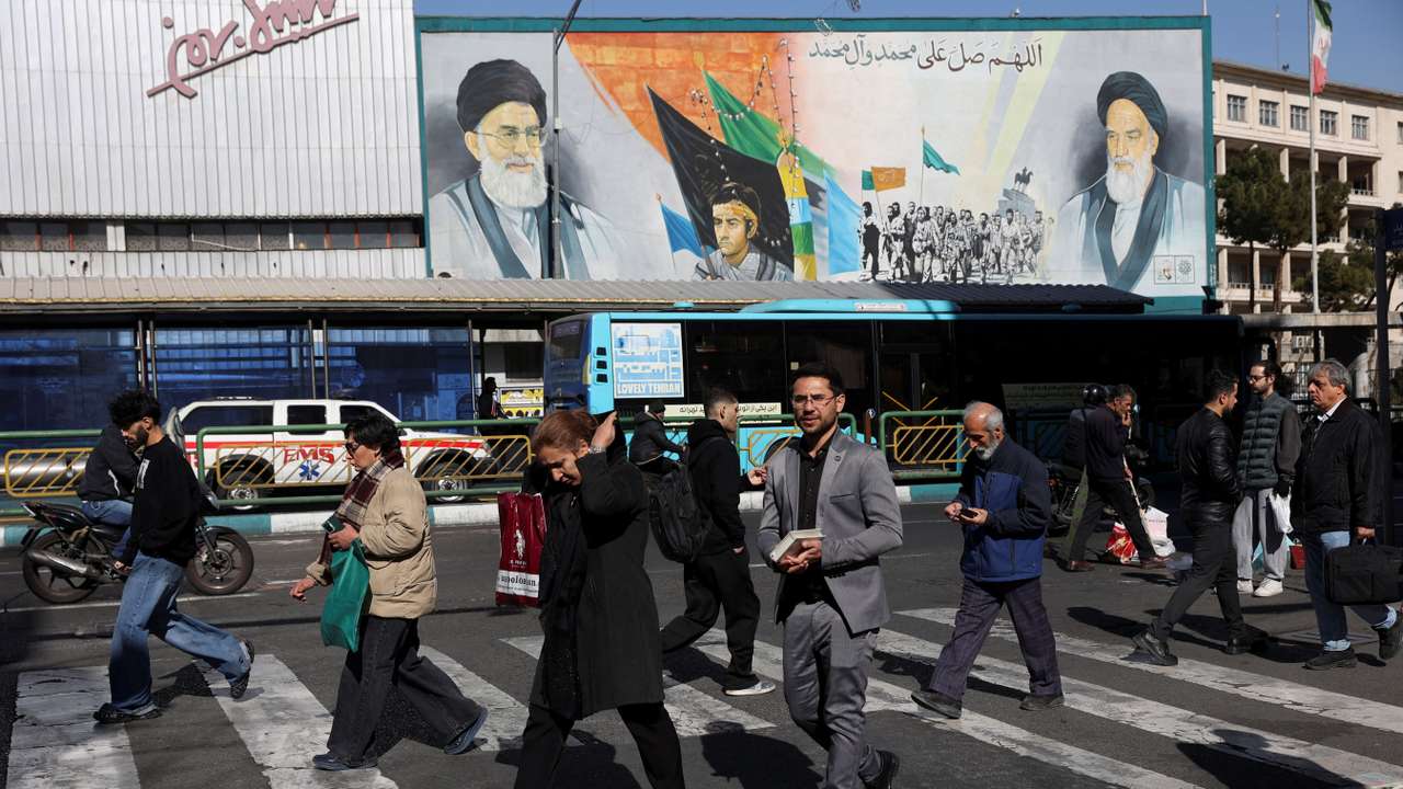 People walk on a street in Tehran