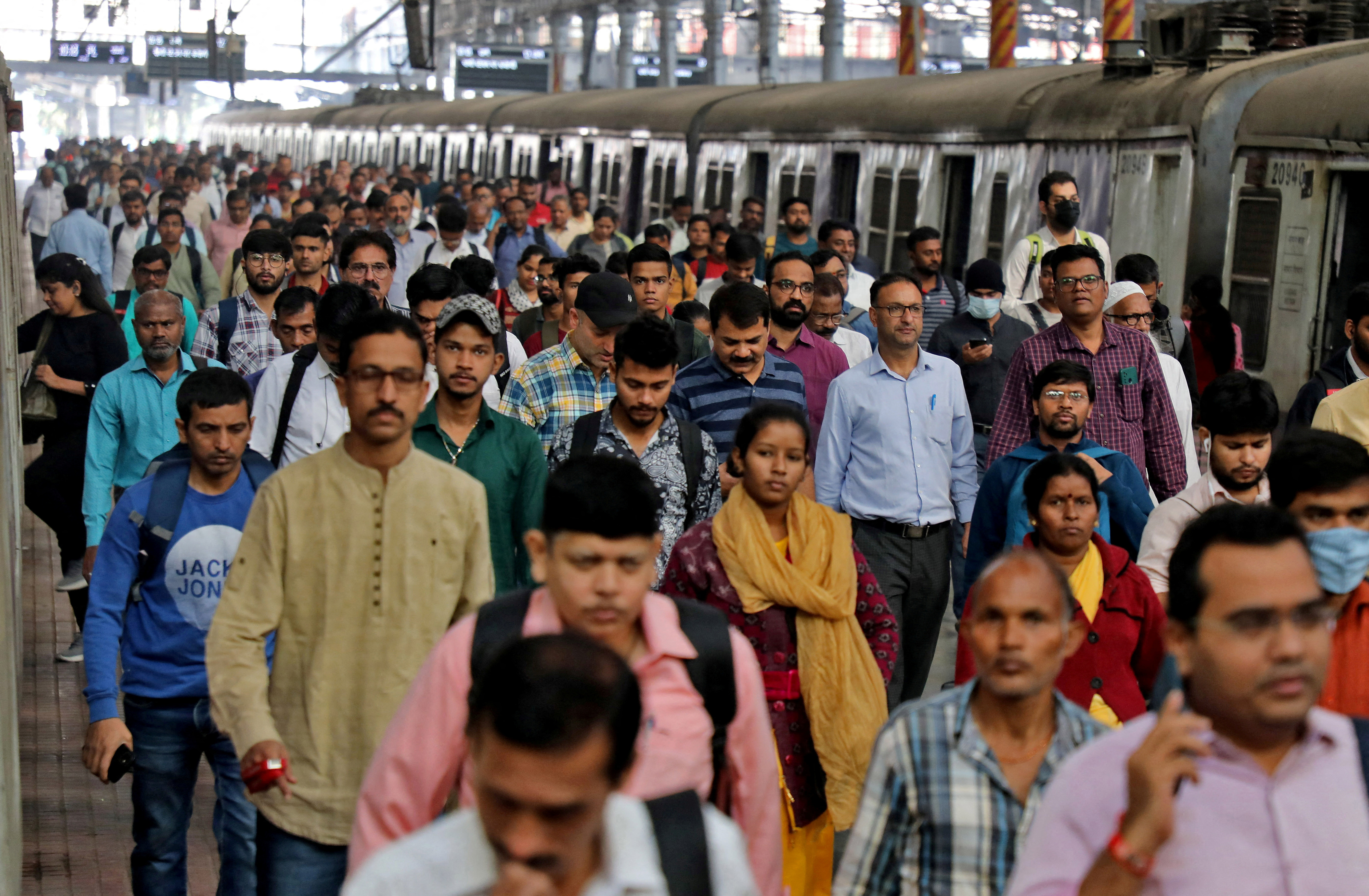 FILE PHOTO: Commuters walk on a platform after disembarking from a suburban train, in Mumbai