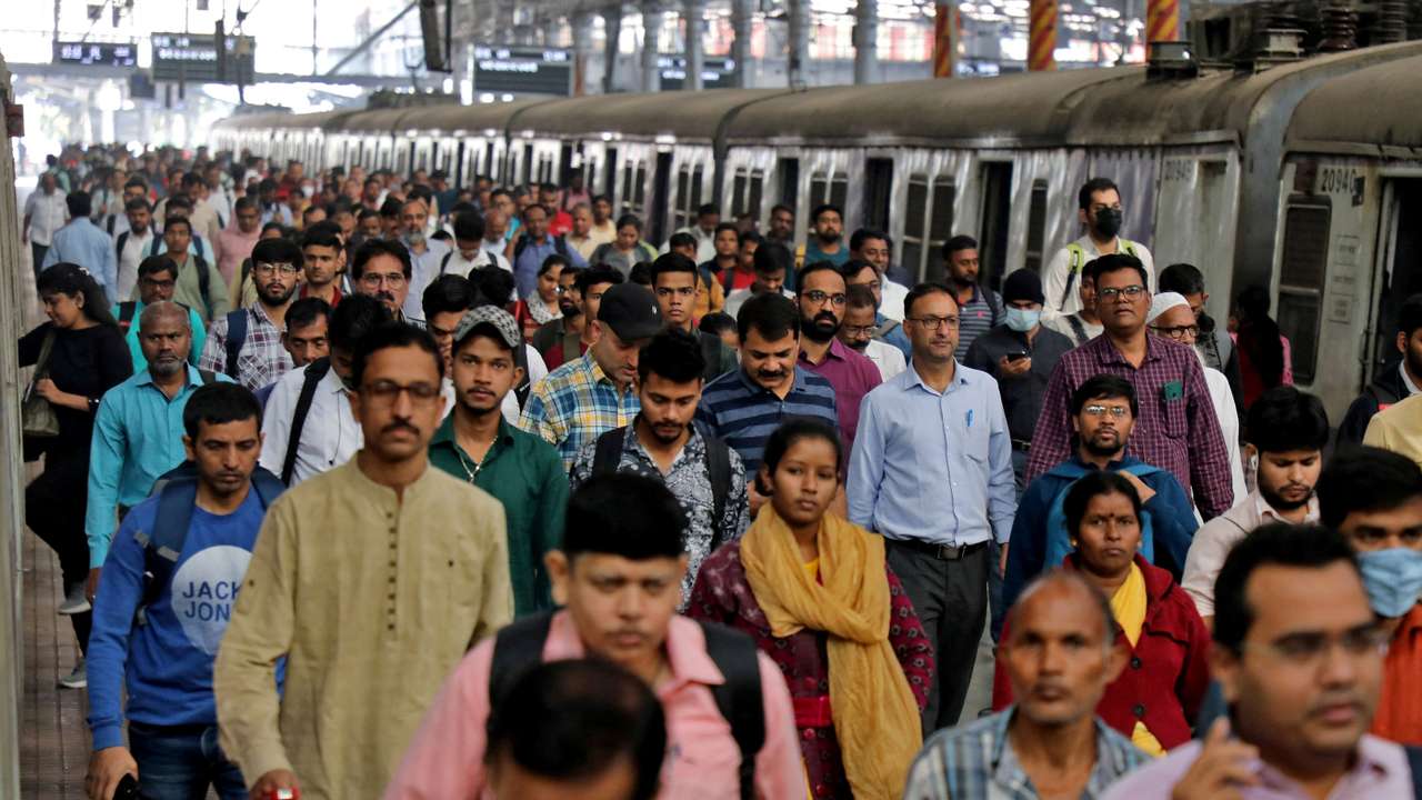 FILE PHOTO: Commuters walk on a platform after disembarking from a suburban train, in Mumbai
