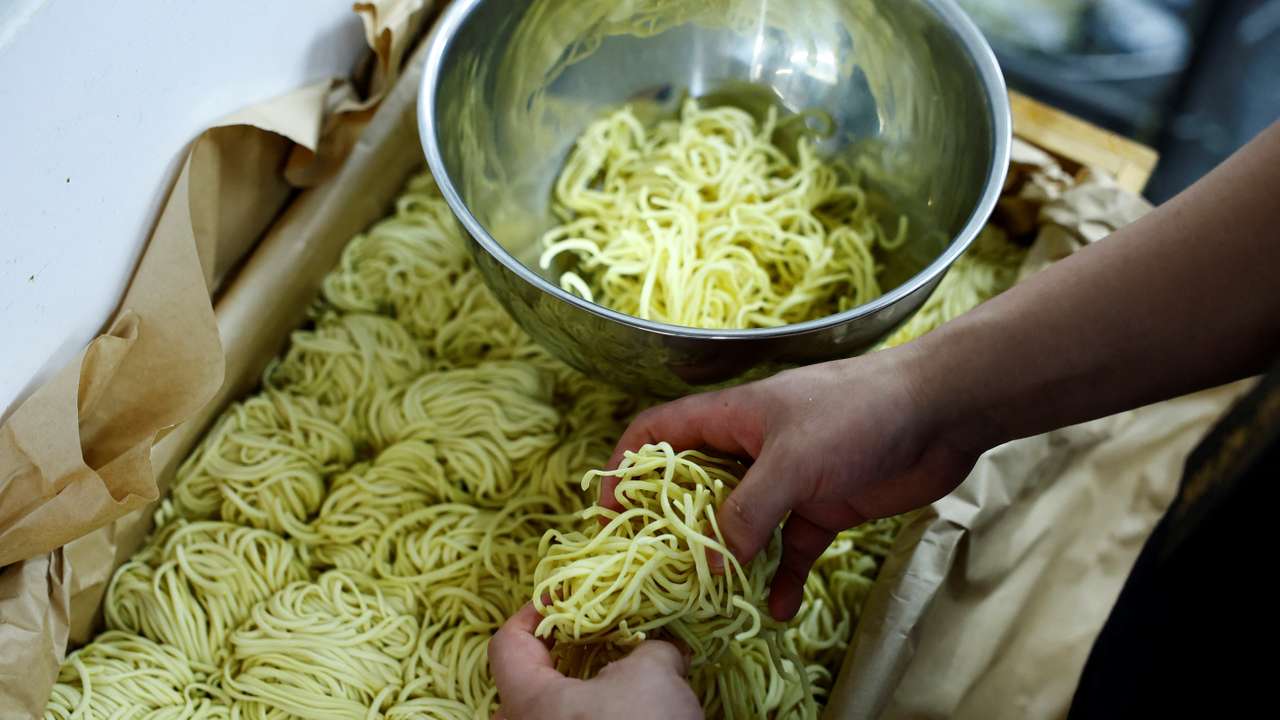 Ramen shop Menya Taisei's owner Taisei Hikage prepares to cook ramen with noodles at his shop in Tokyo