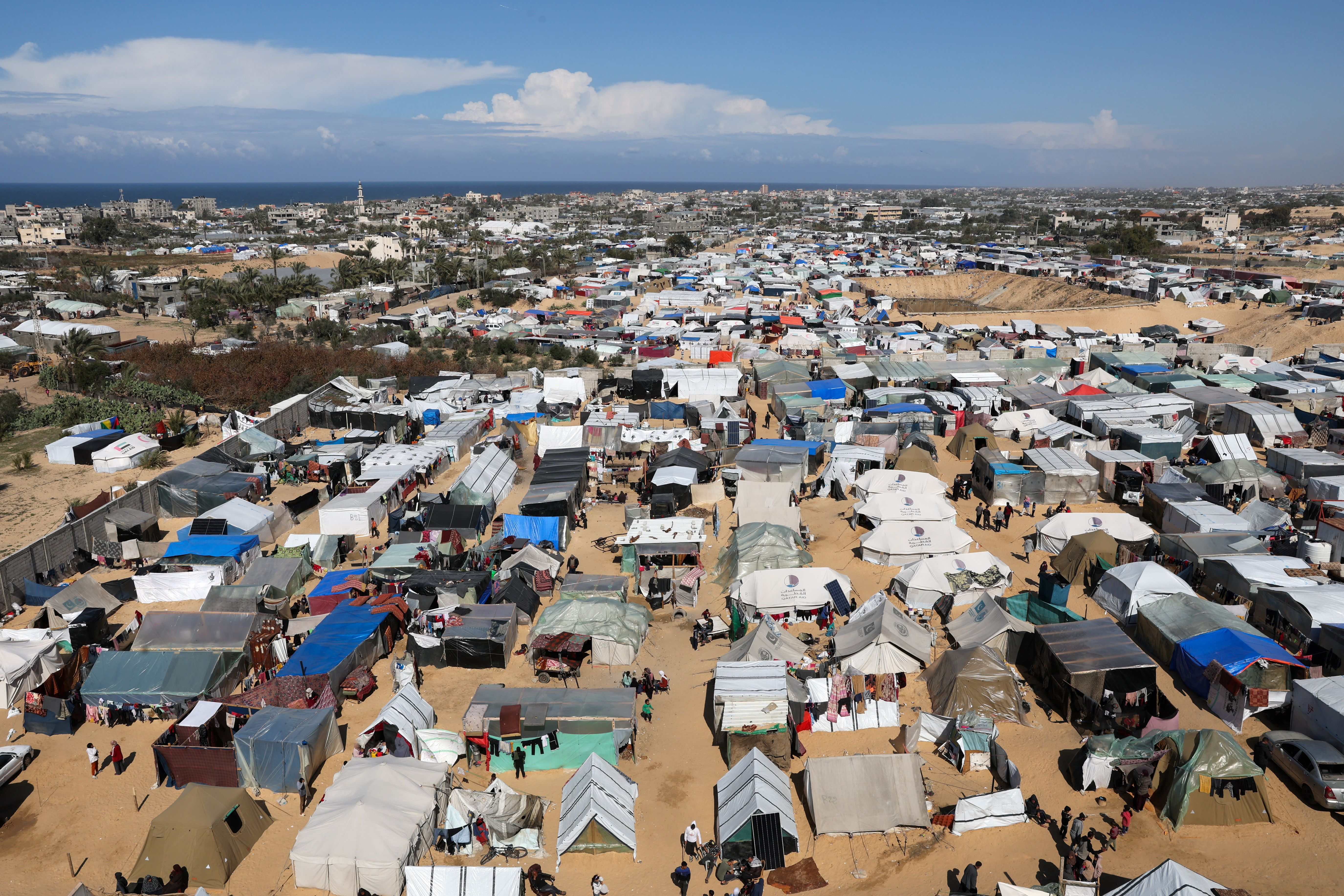 Displaced Palestinian, who fled their houses due to Israeli strikes, take shelter in a tent camp in Rafah