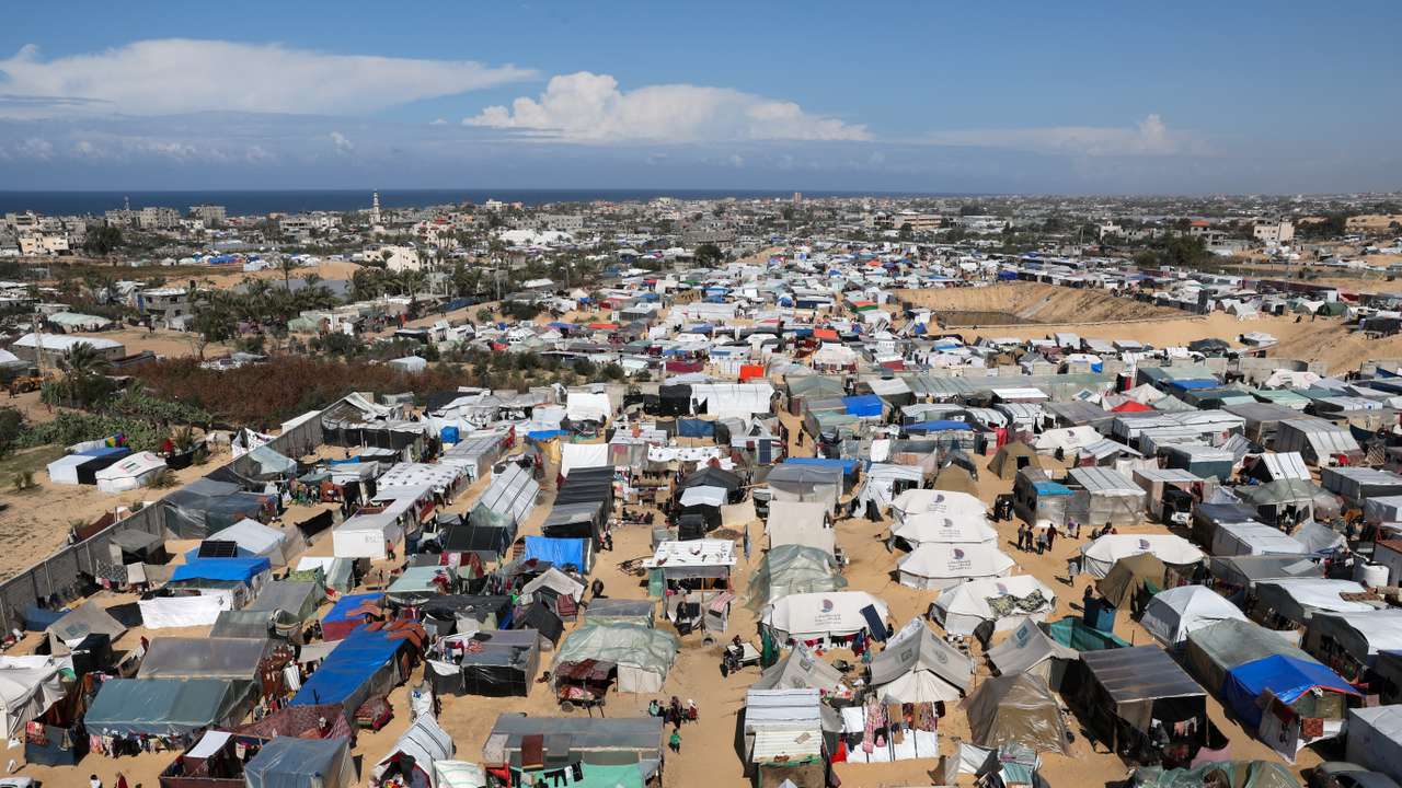 Displaced Palestinian, who fled their houses due to Israeli strikes, take shelter in a tent camp in Rafah