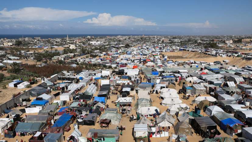 Displaced Palestinian, who fled their houses due to Israeli strikes, take shelter in a tent camp in Rafah