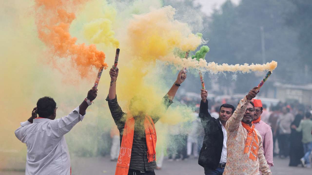 FILE PHOTO: Supporters of India's ruling Bharatiya Janata Party (BJP) celebrate after winning three out of four states in key regional polls outside the party headquarters in Ahmedabad