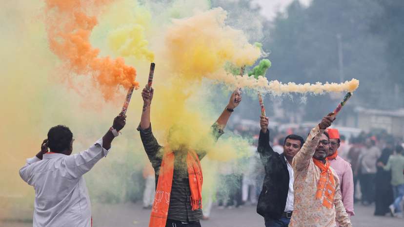 FILE PHOTO: Supporters of India's ruling Bharatiya Janata Party (BJP) celebrate after winning three out of four states in key regional polls outside the party headquarters in Ahmedabad