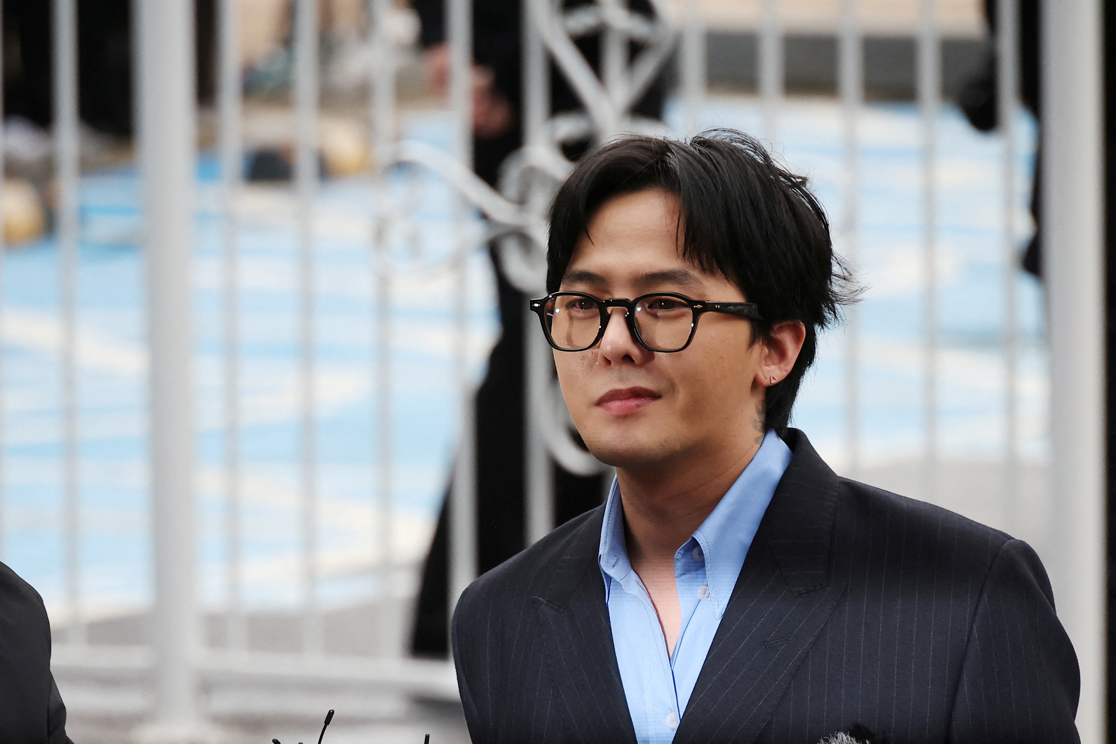 FILE PHOTO: G-dragon of K-pop group BIGBANG arrives at a police station for questioning regarding his alleged illegal drug use in Incheon