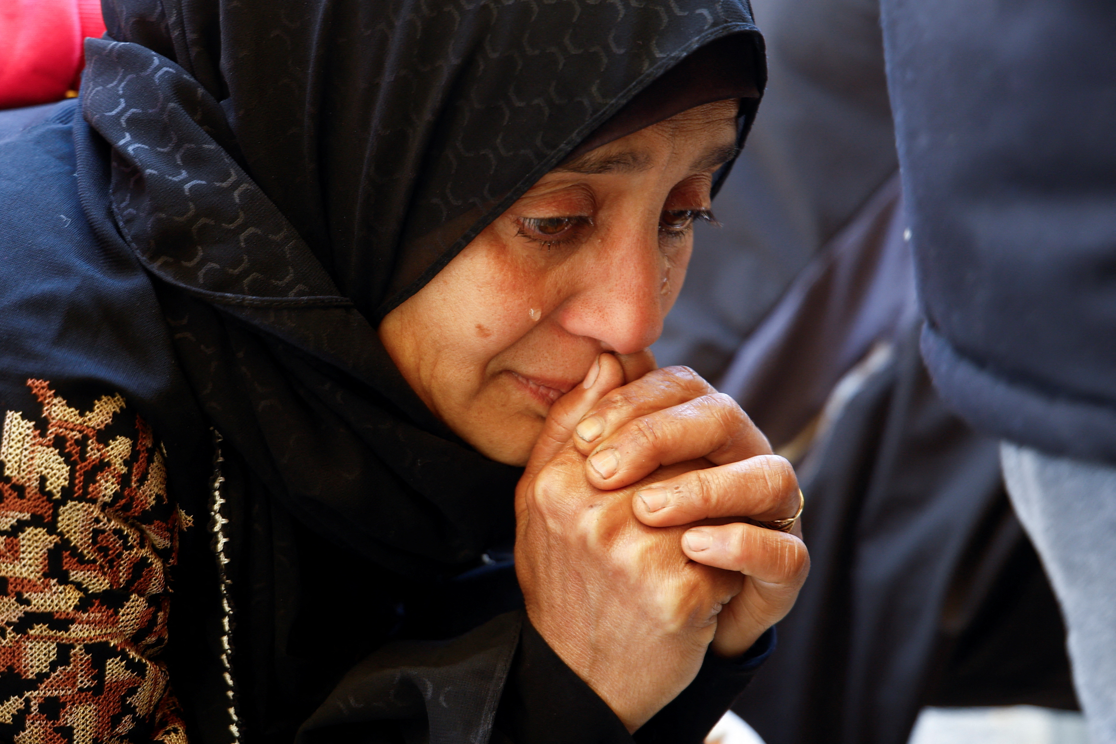 Palestinians mourn at a hospital after an Israeli strike killed three policemen, according to the Hamas-run interior ministry, in Khan Younis