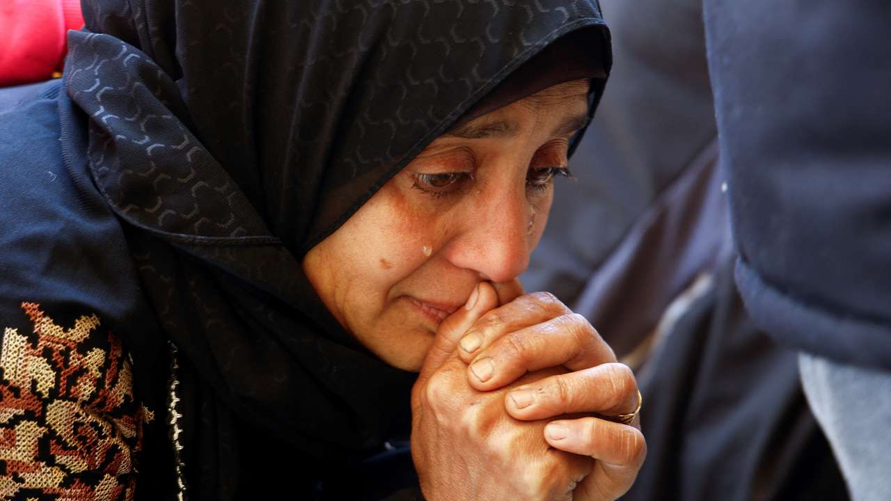Palestinians mourn at a hospital after an Israeli strike killed three policemen, according to the Hamas-run interior ministry, in Khan Younis