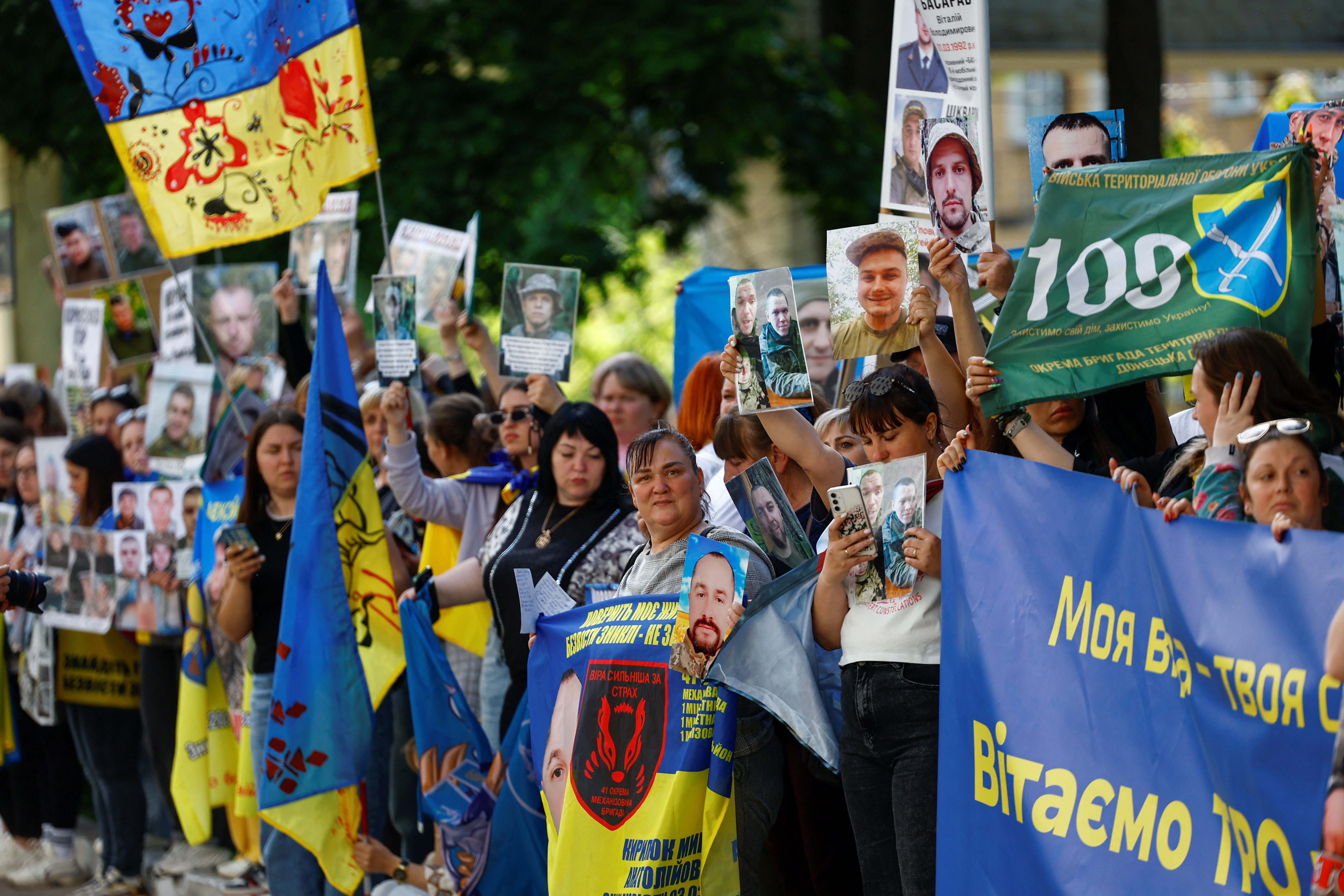 Relatives of Ukrainian prisoners of war wait for their arrival after a swap in an undisclosed location in Ukraine