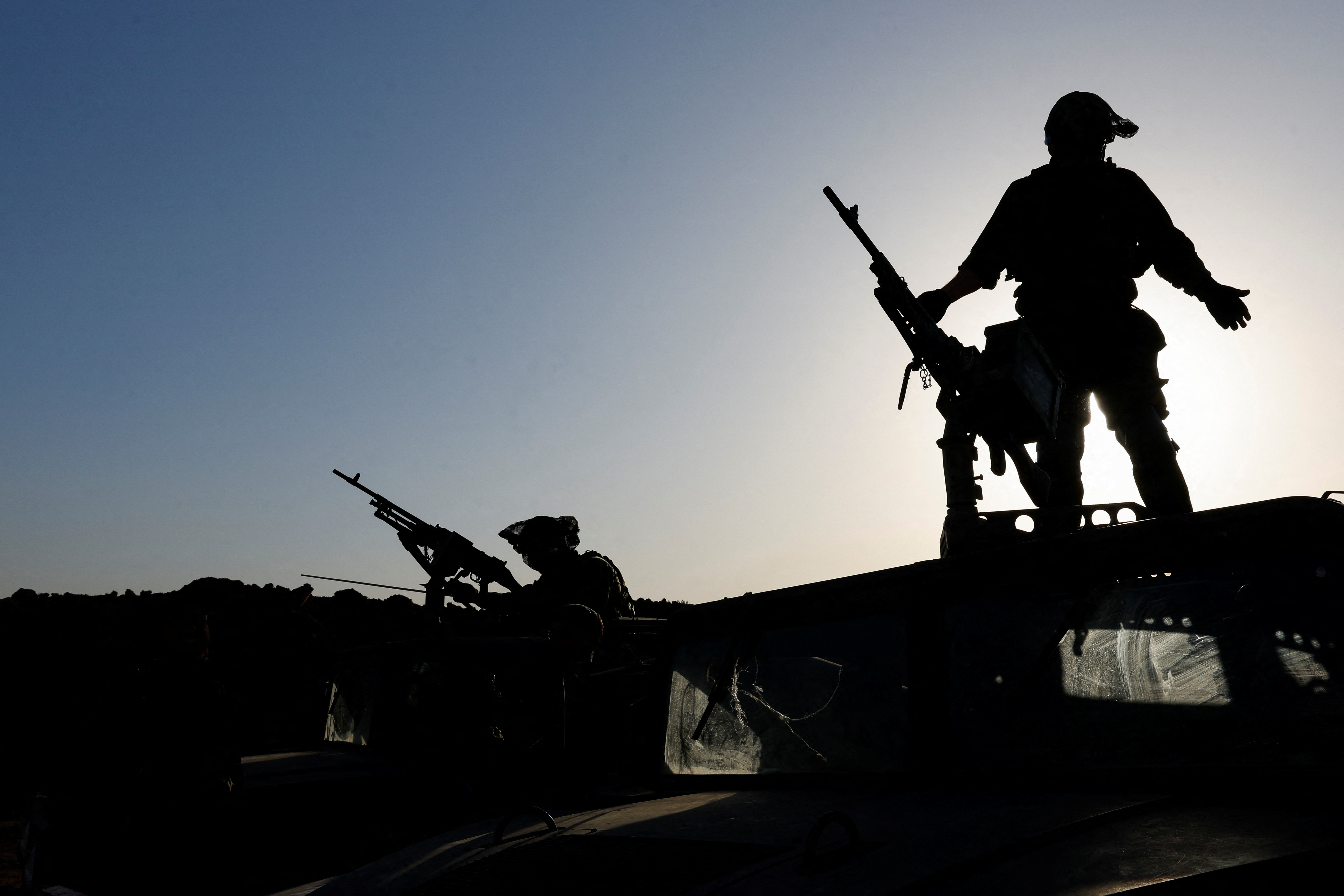 Israeli soldiers gather on the Israeli side of the Israel-Gaza border