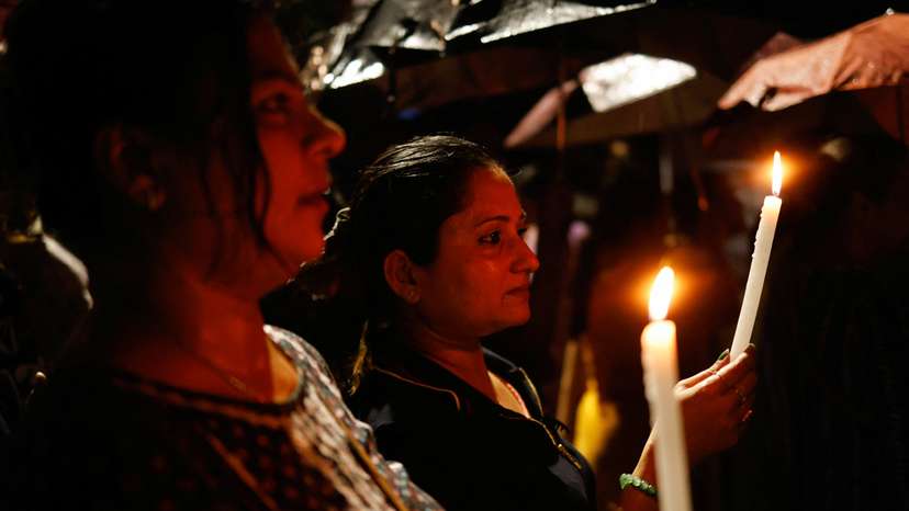 Women hold candles as they attend a candlelight vigil condemning the rape and murder of a trainee medic at a government-run hospital in Kolkata