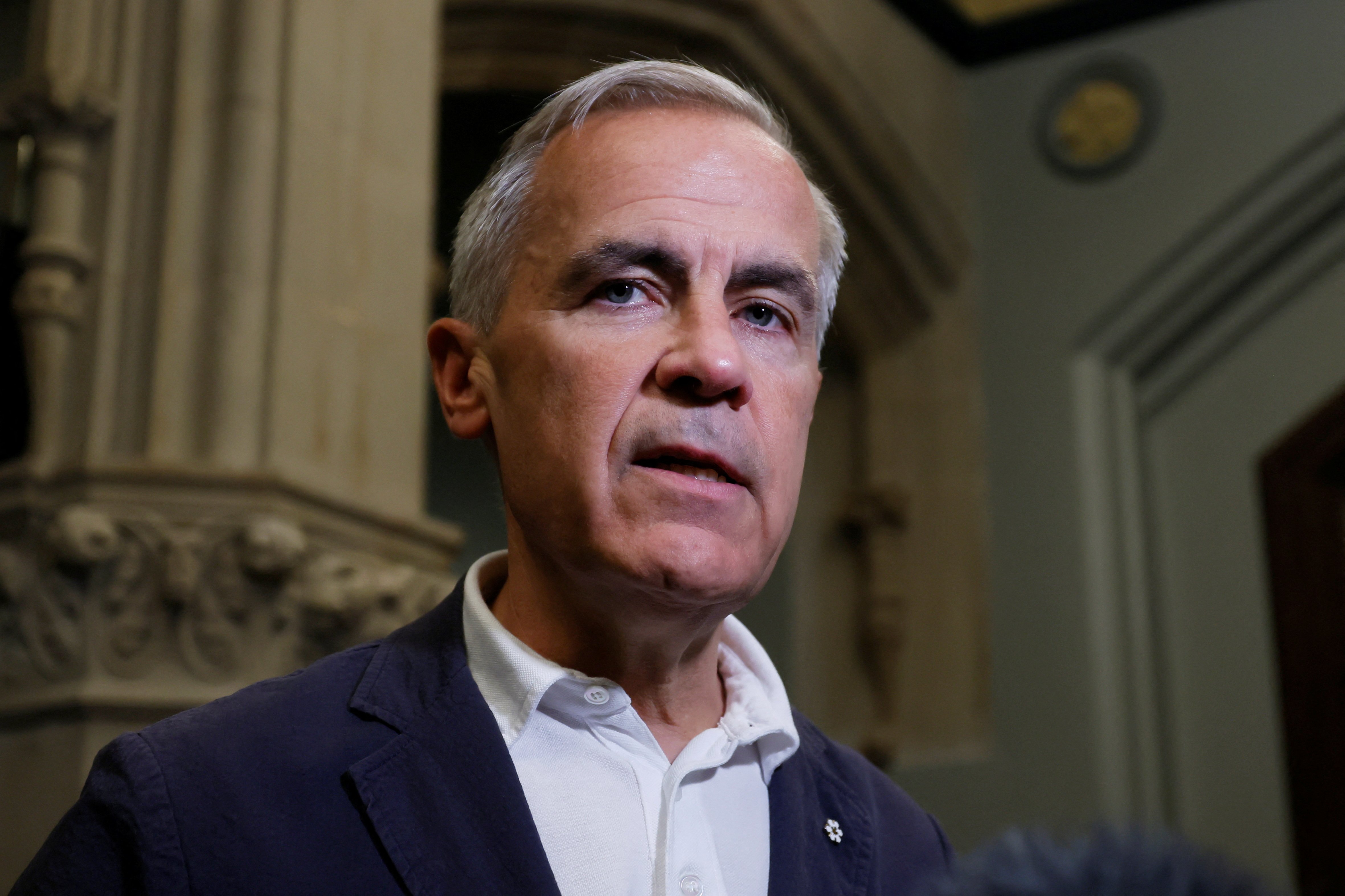 Canada's Prime Minister Carney speaks to journalists outside his office on Parliament Hill in Ottawa