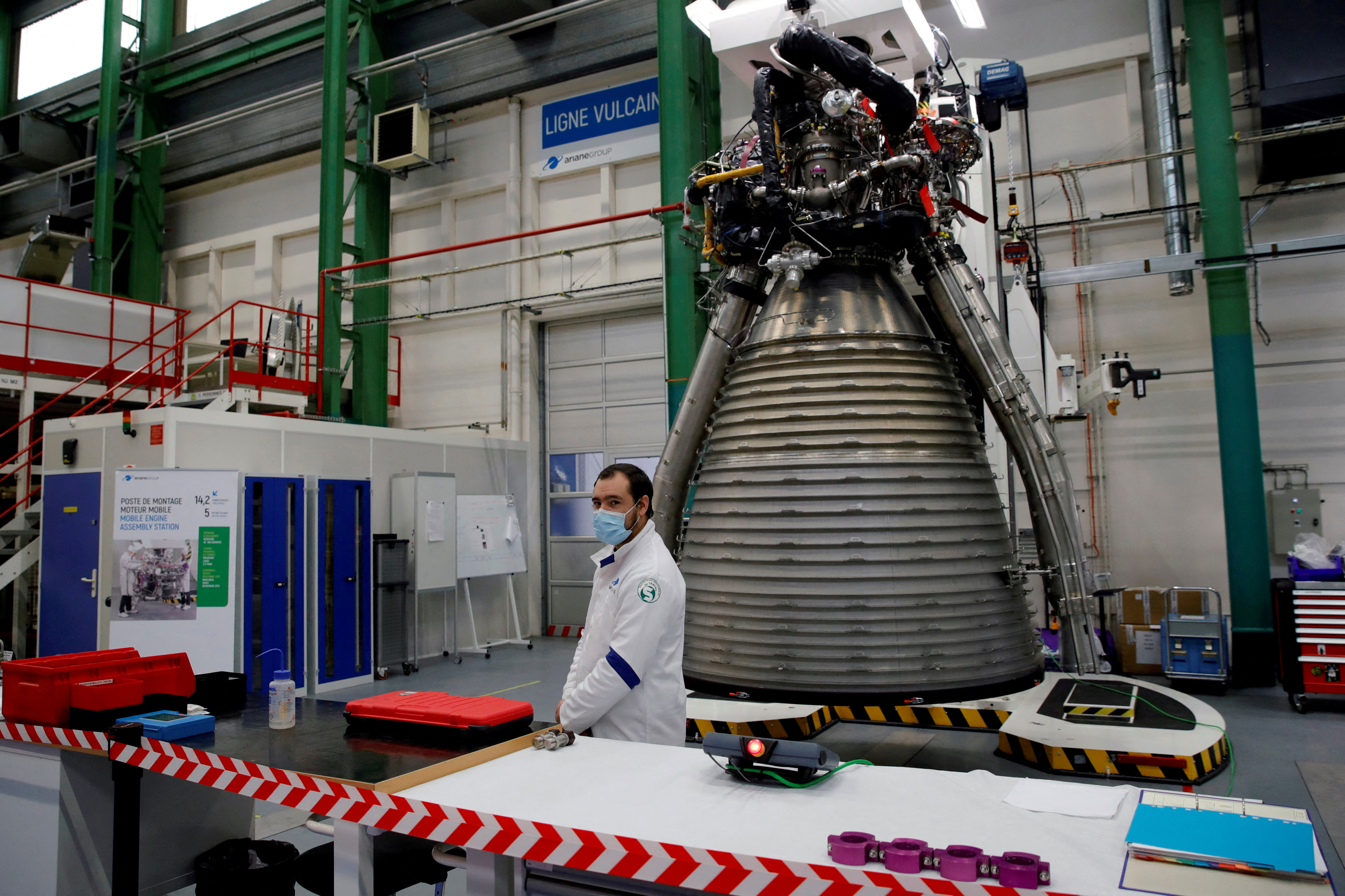 FILE PHOTO: A worker of Ariane Group stands in front of a Ariane 6 rocket's Vulcain 2.1 engine, prior to the visit of French President Emmanuel Macron, in Vernon