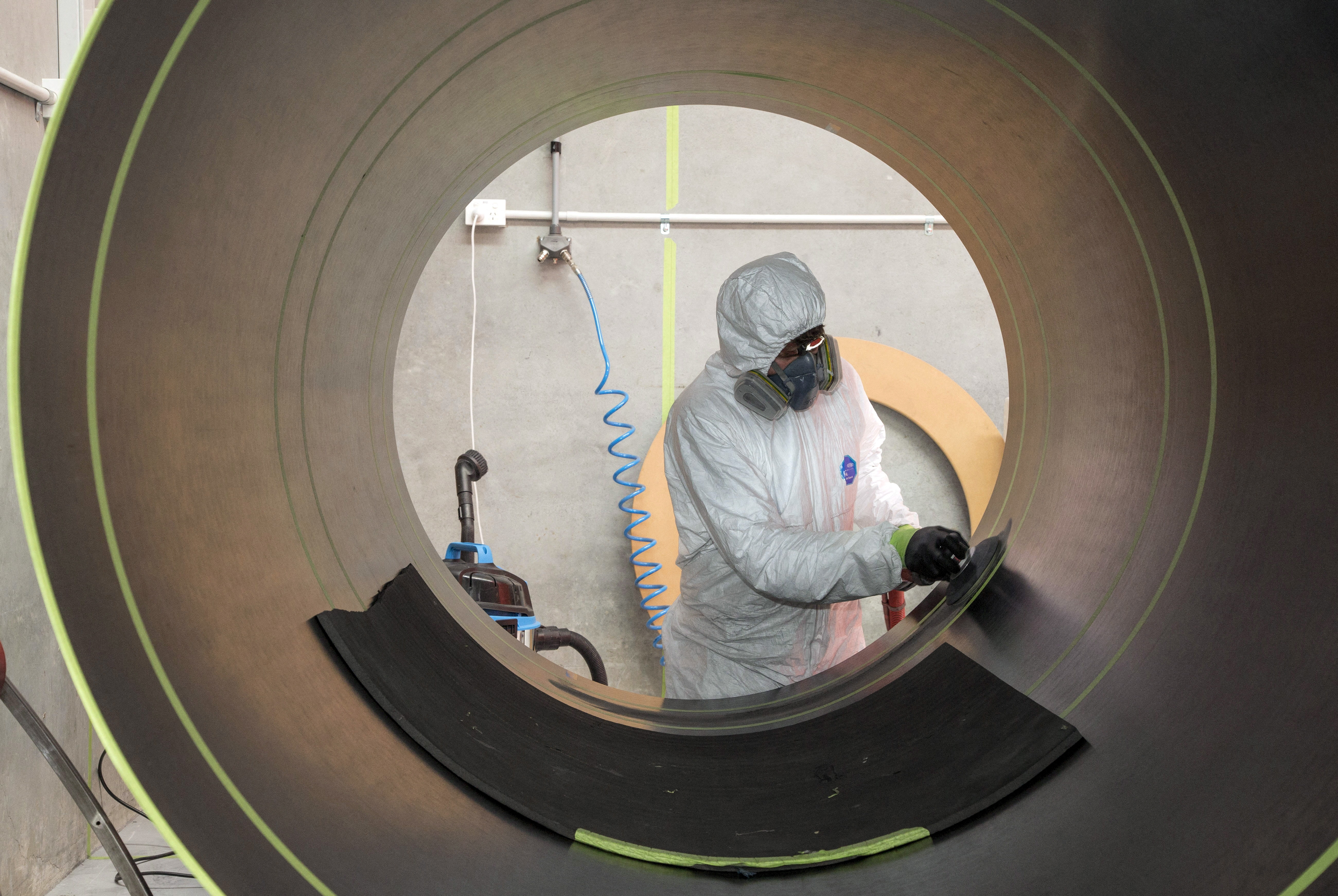 A Rocket Lab technician cleans a fuselage in Auckland, New Zealand